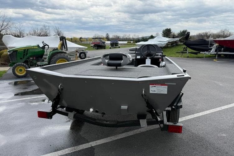 2026 Crestliner 1600 Storm boat on trailer in outdoor parking lot.