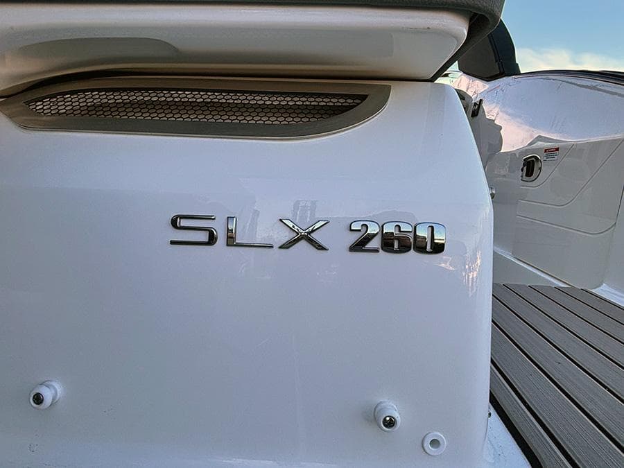 2025 Sea Ray SLX 260 Outboard boat, close-up of model name on white hull.