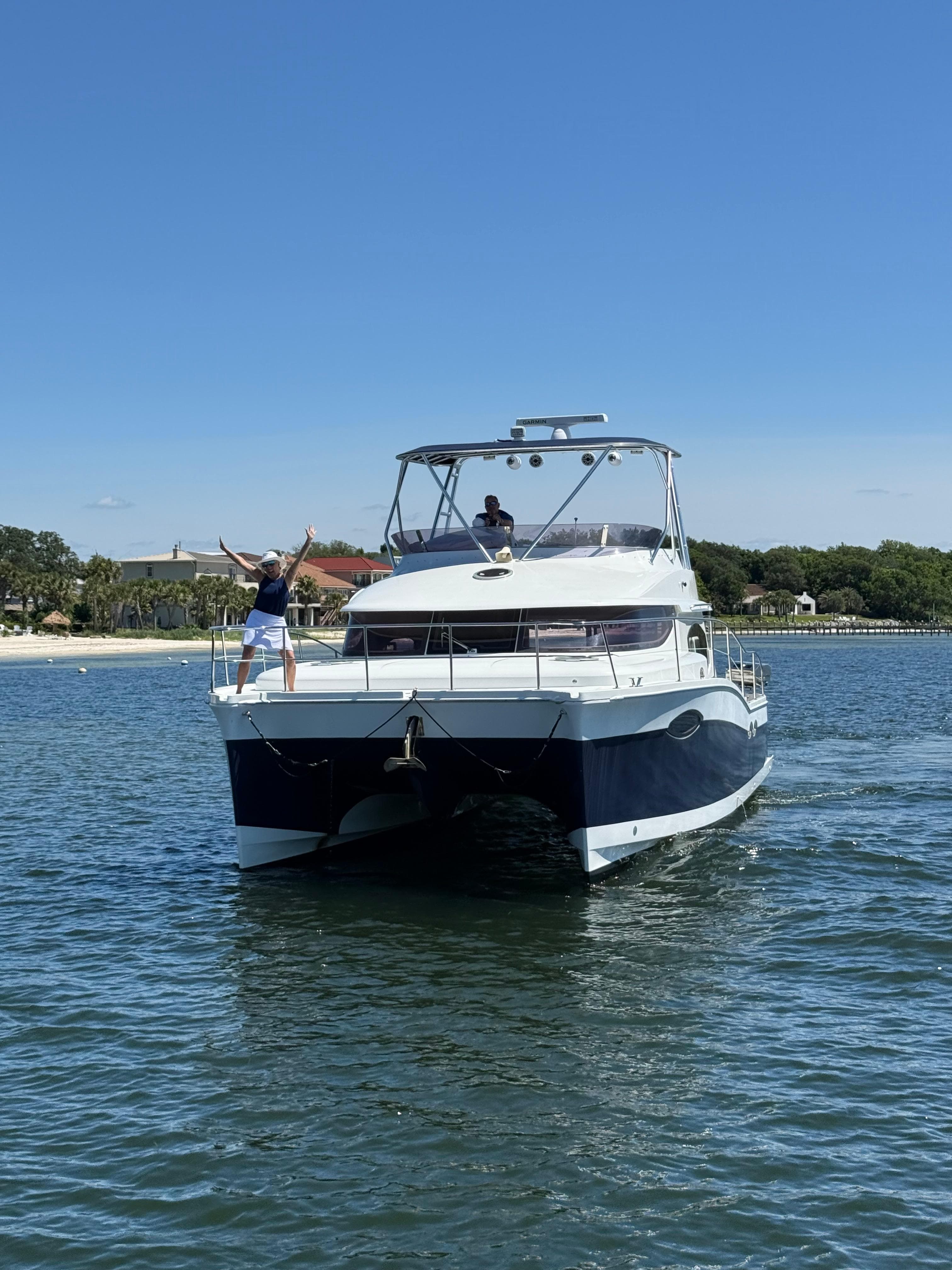 Fountaine Pajot 40 catamaran cruising on water, 2012 model, with people enjoying the ride.