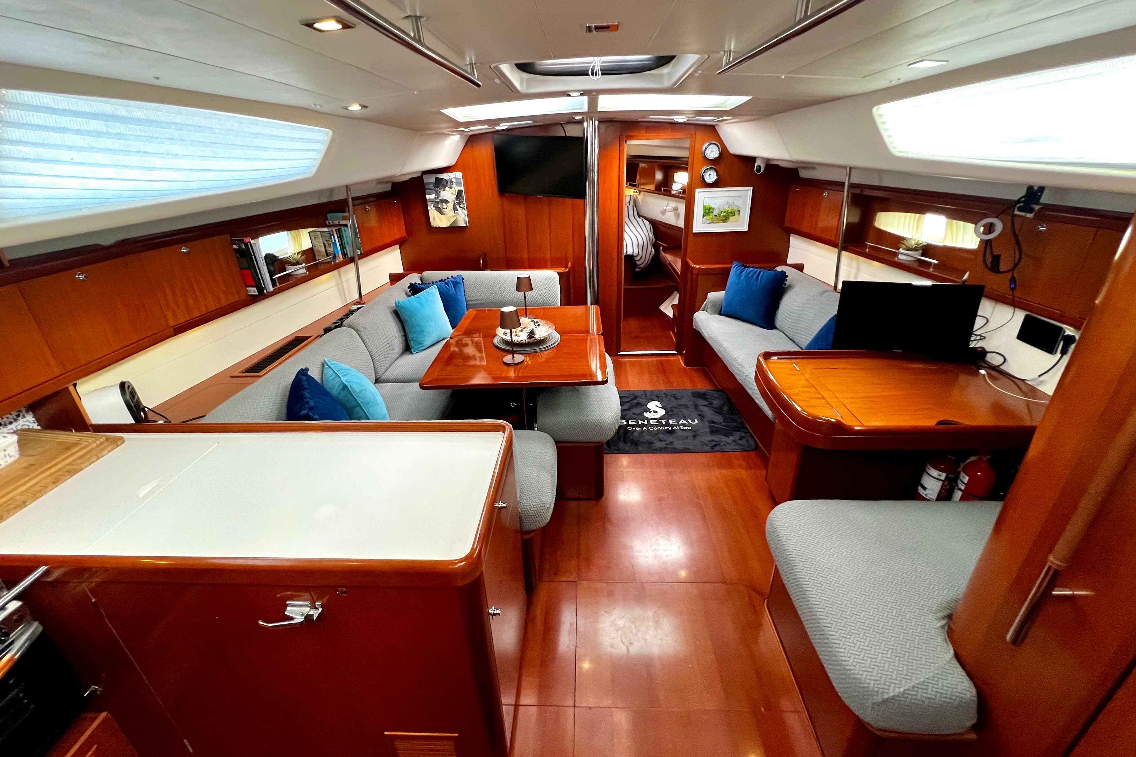 Luxurious interior of 2006 Beneteau Oceanis 50 yacht with elegant wood finish and cozy seating.