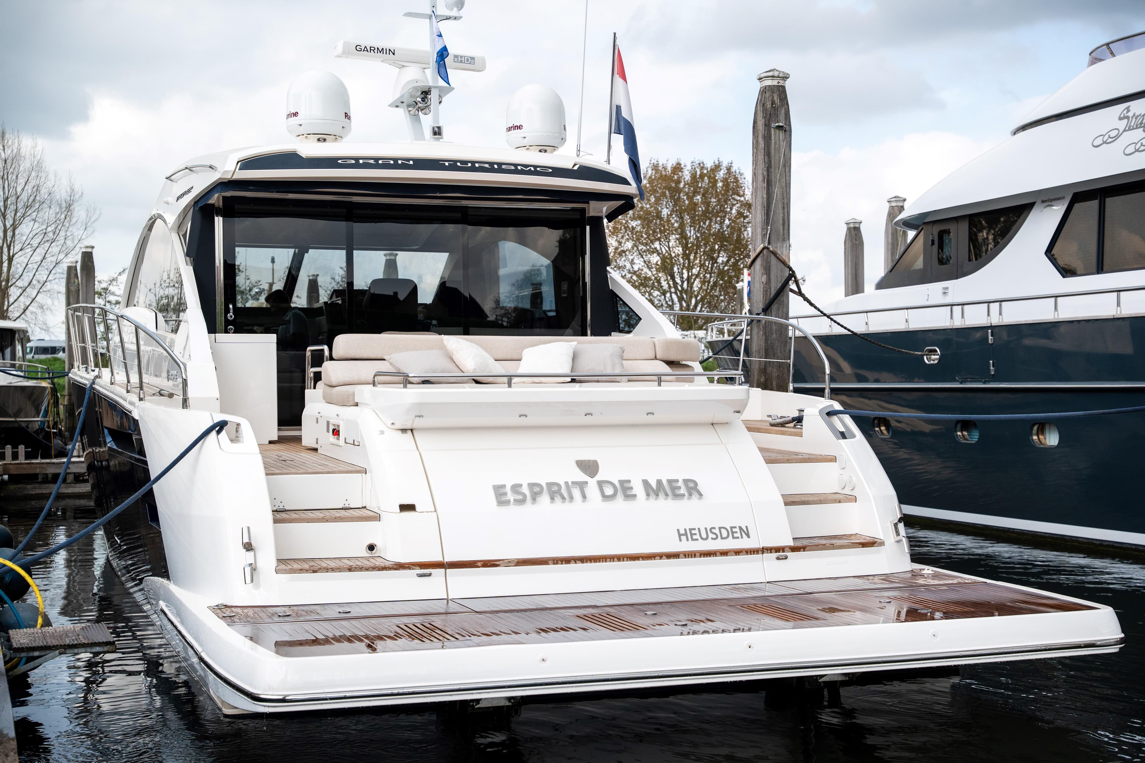 2015 Fairline Targa 62 GT yacht docked, rear view with seating and "Esprit de Mer" text.