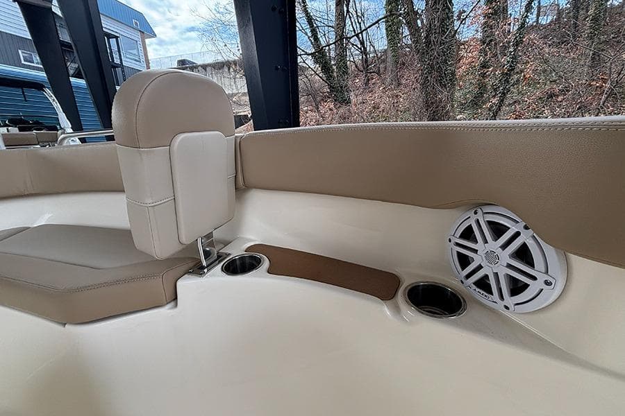 2024 Scout 215 XSF boat interior with beige seating, cup holders, and speaker.
