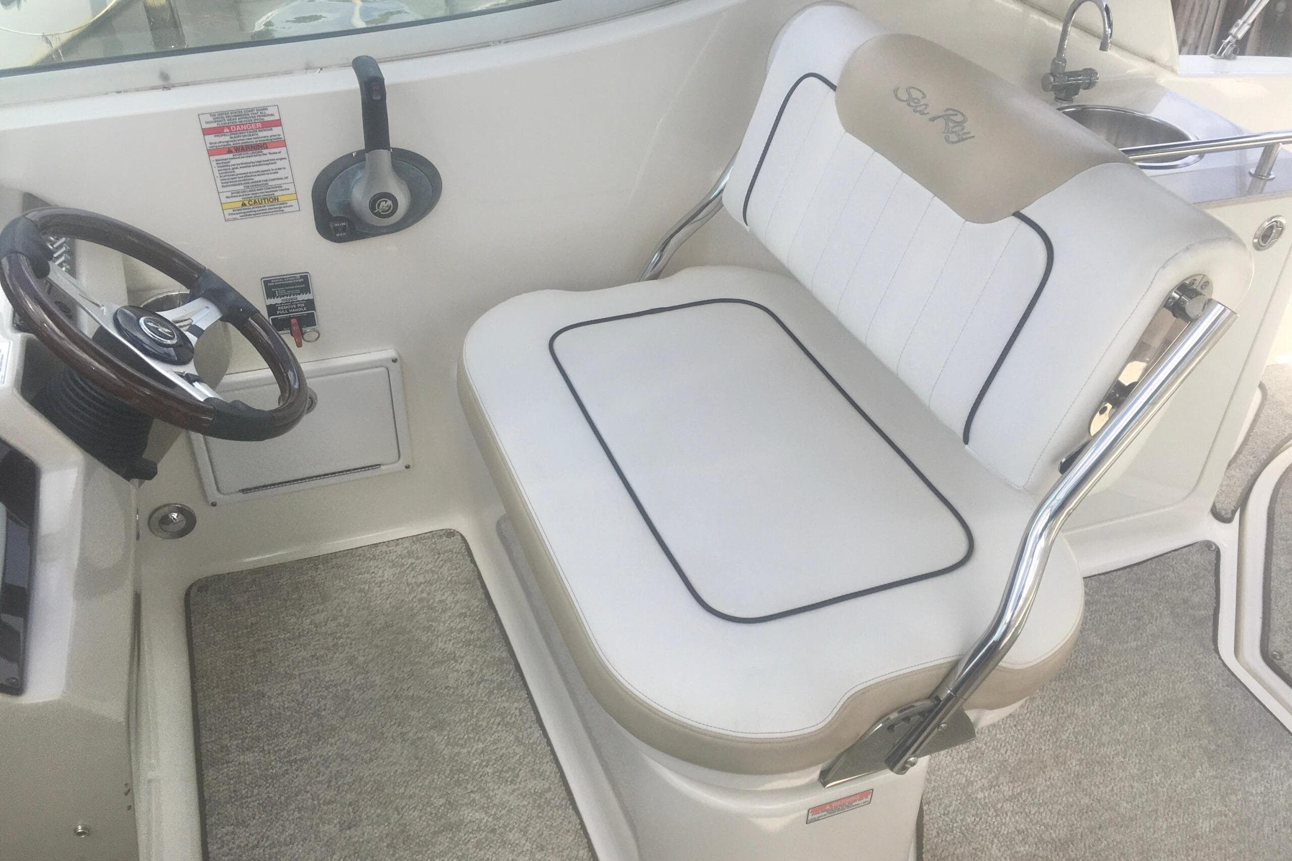 2010 Sea Ray 260 Sundancer helm with steering wheel and cushioned seat.