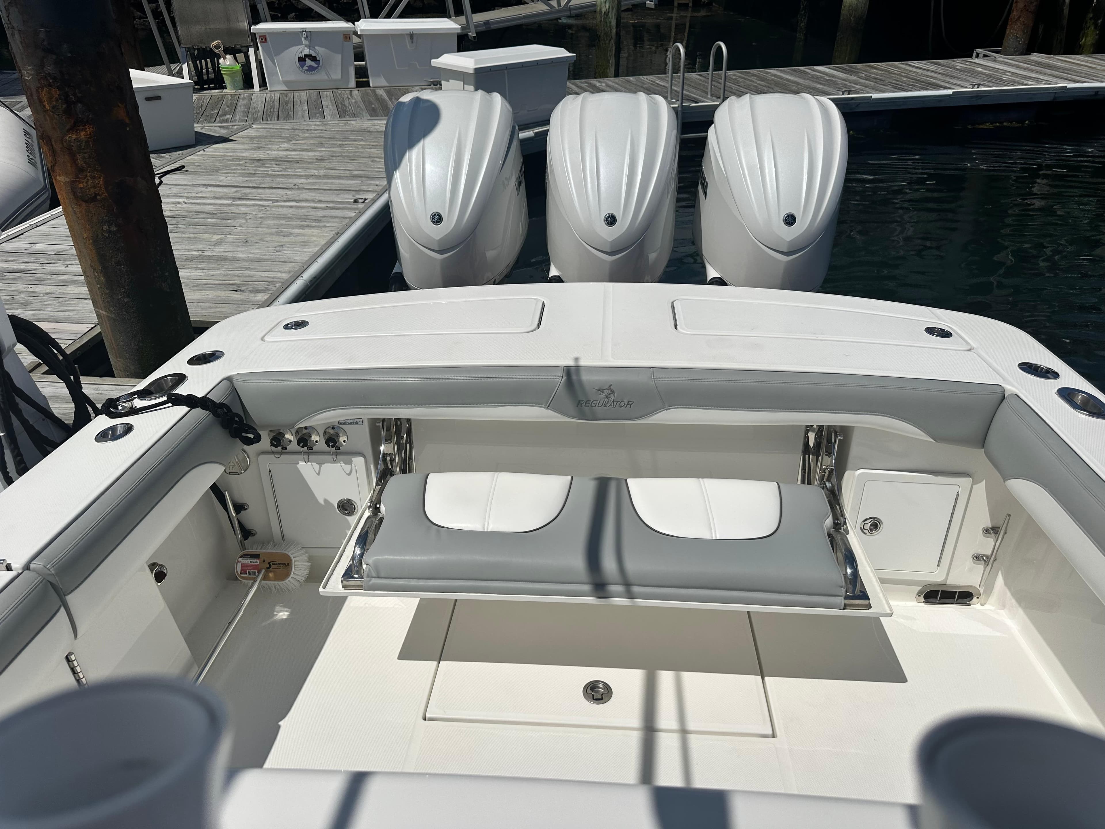 2022 Regulator 34 boat with triple engines docked at marina.