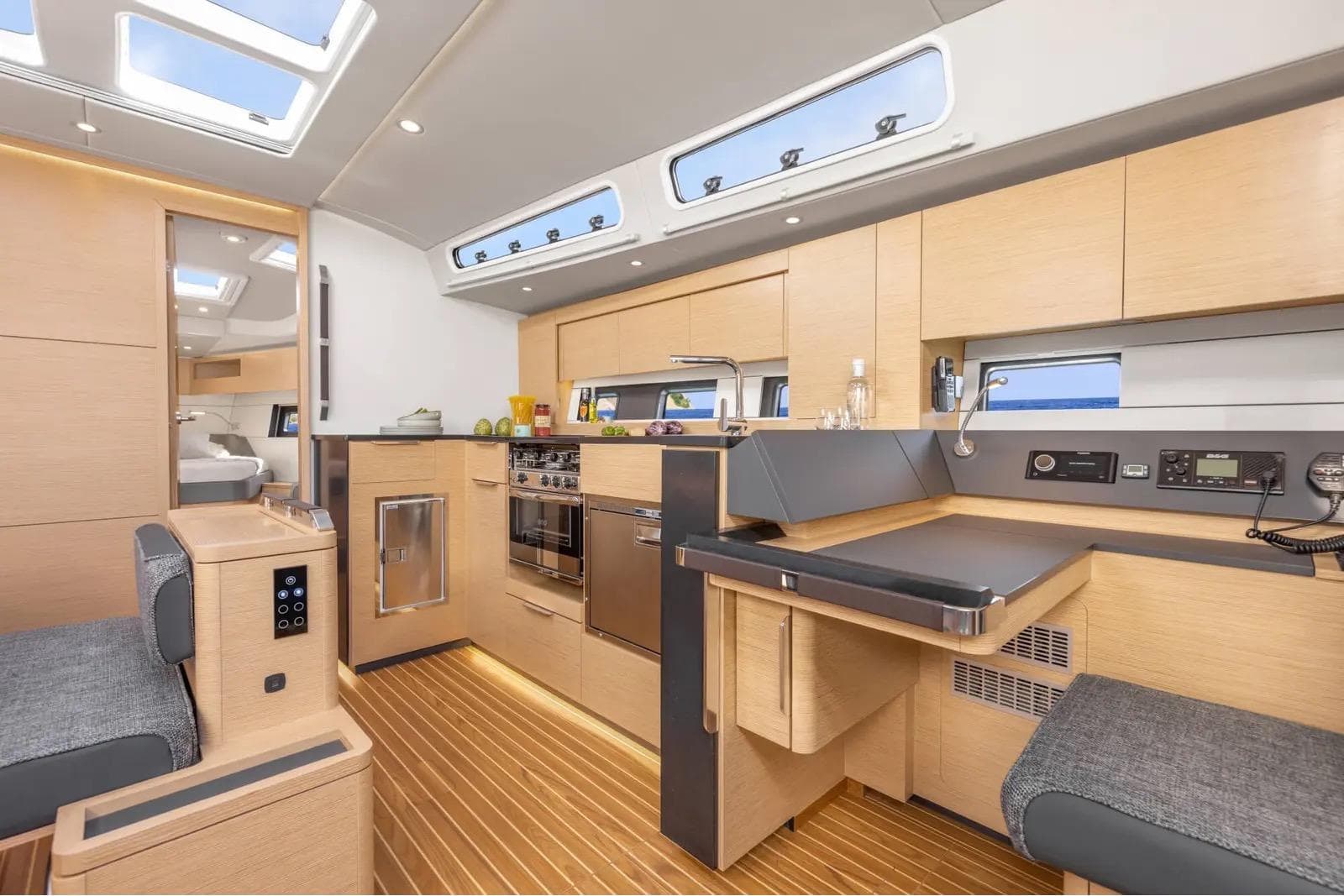 Modern interior of 2024 Hanse 460 yacht, featuring sleek kitchen and dining area.