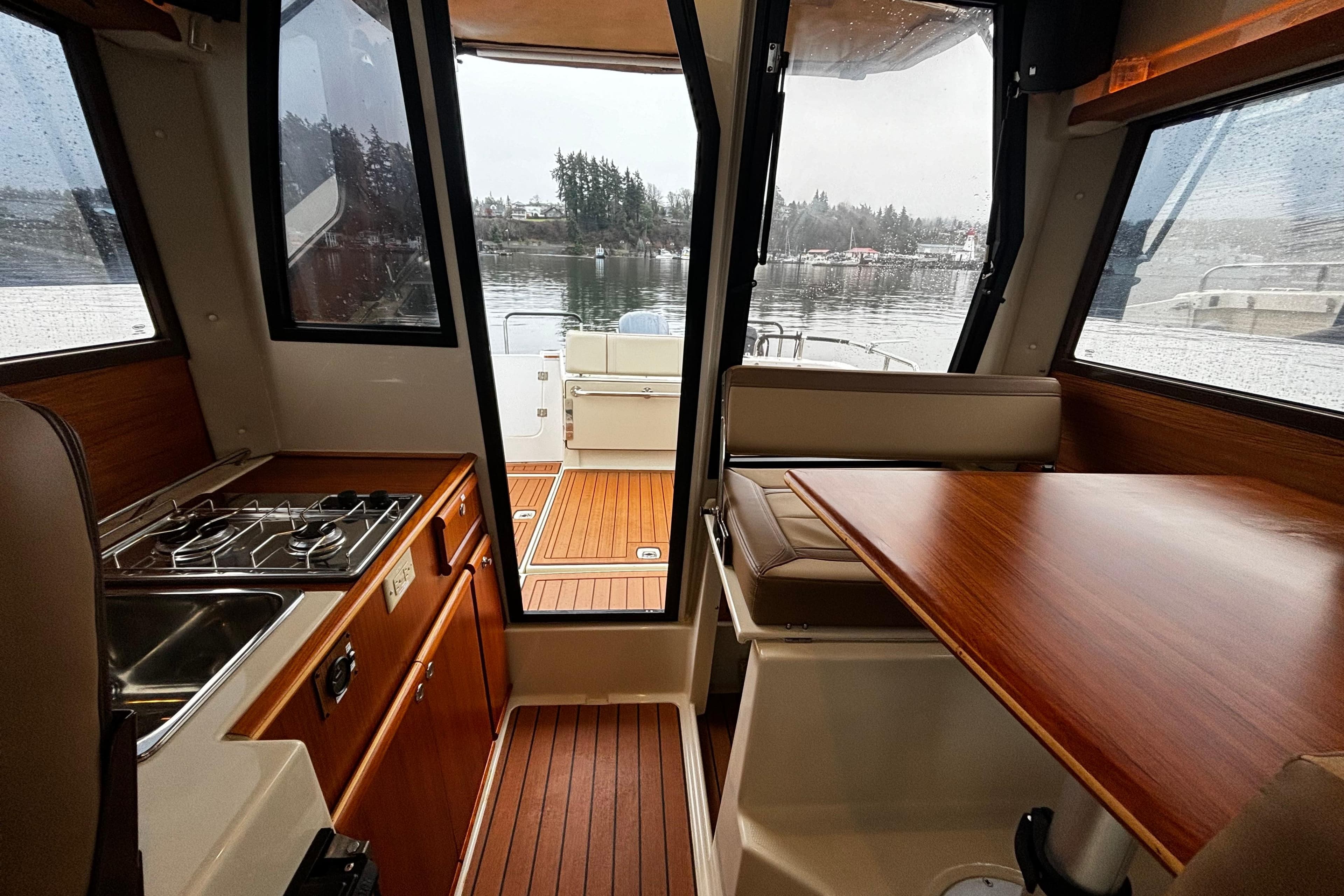 Interior of 2022 Ranger Tugs R-23 boat with kitchen and dining area.