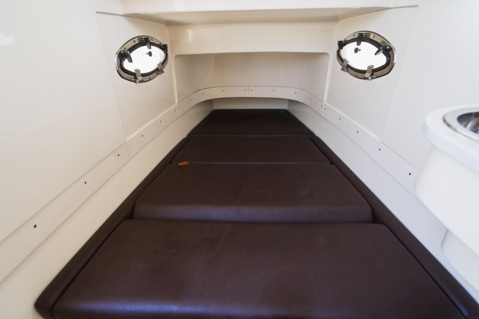 2022 Scout 305 LXF cabin interior with cushioned seating and portholes.