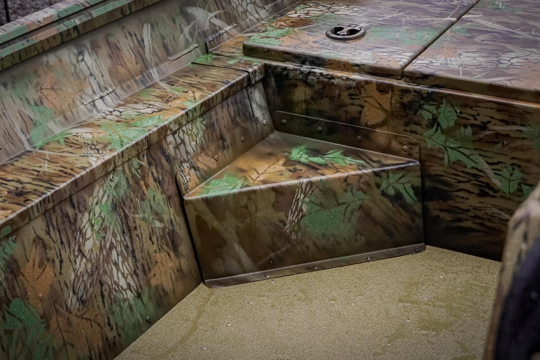 Camouflage interior of 2026 G3 17SC boat with textured seating and storage.