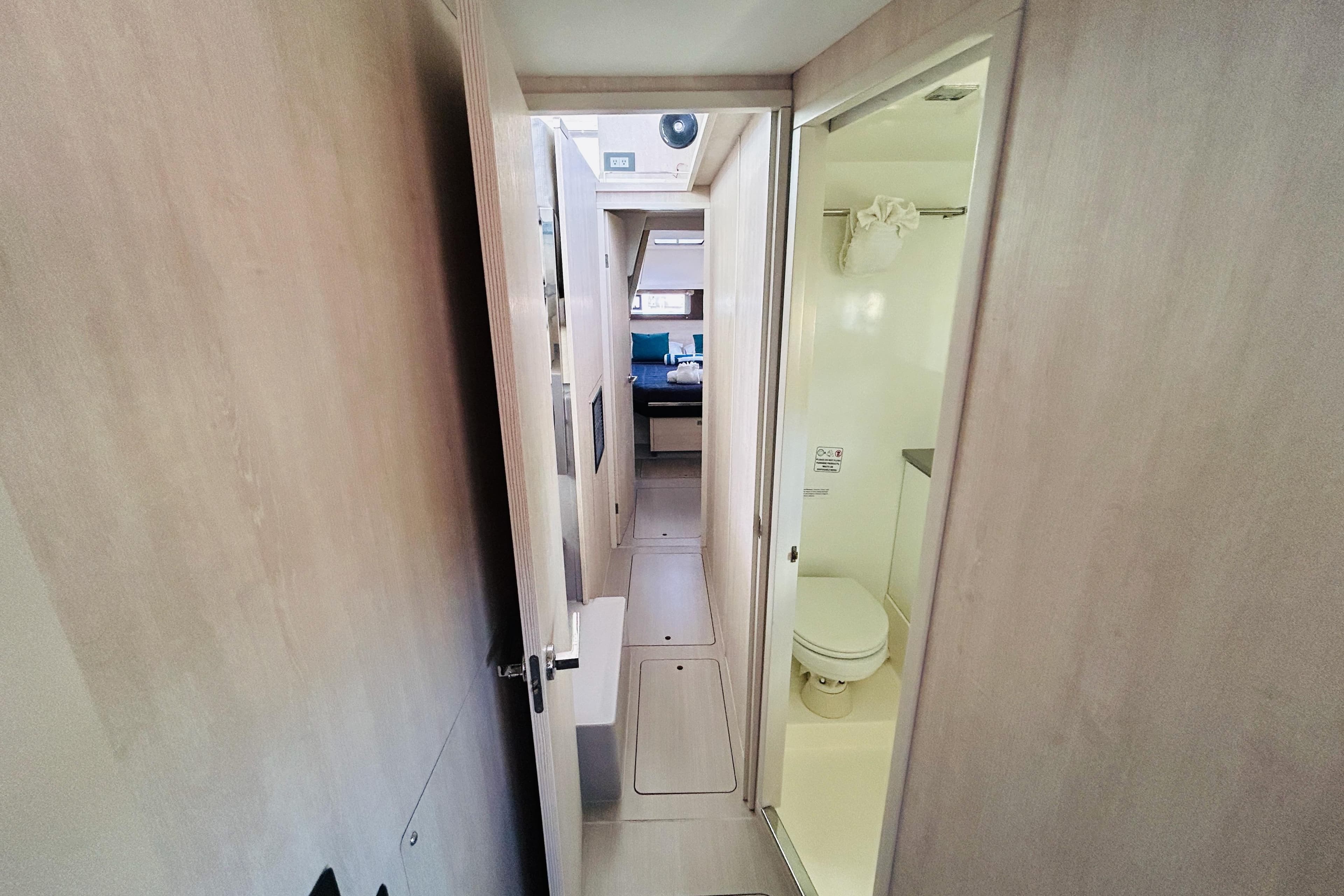 Interior of a 2021 Leopard 45 yacht, featuring a compact bathroom and hallway.
