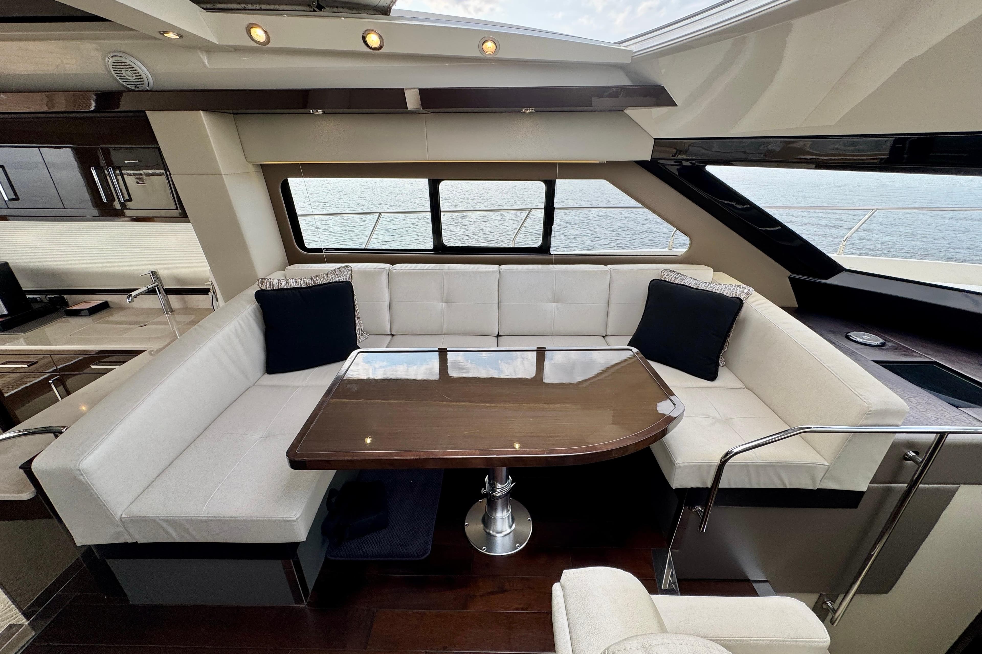 Luxurious interior of 2018 Carver C52 Coupe yacht with elegant seating and table.