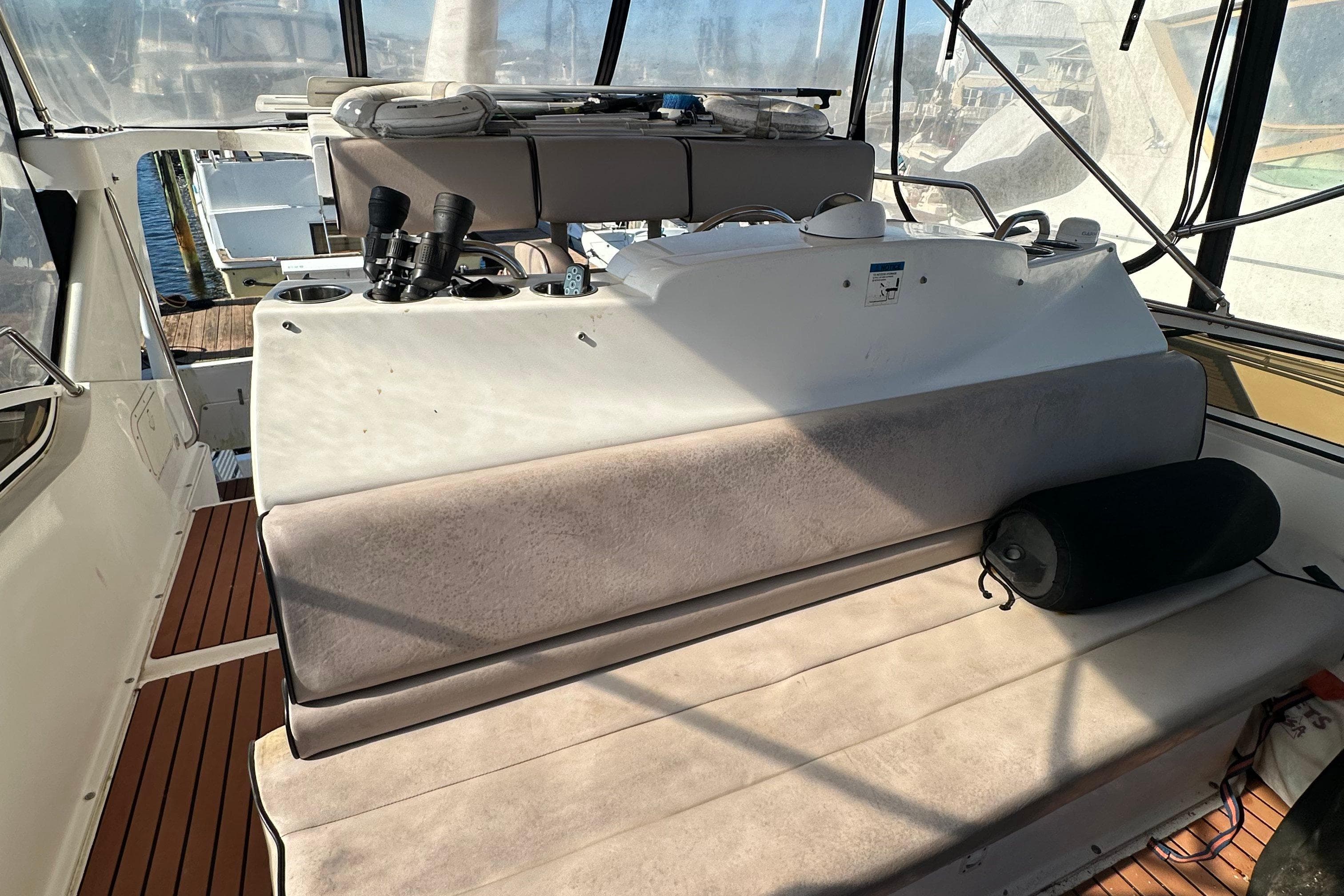 1999 Silverton 442 Cockpit Motor Yacht interior with seating and navigation equipment.