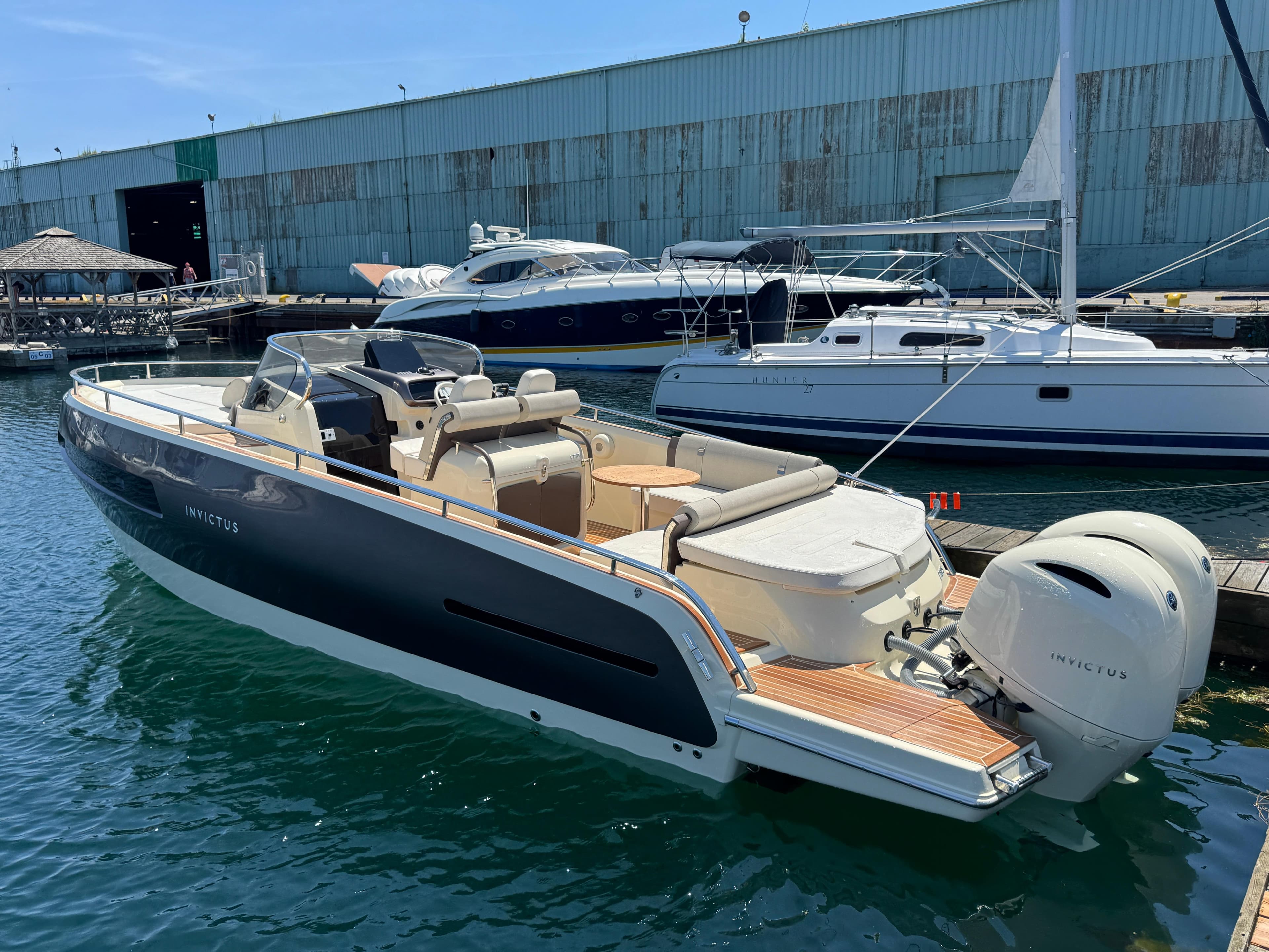 2023 Invictus GT 280S luxury boat docked at marina, showcasing sleek design and powerful engines.