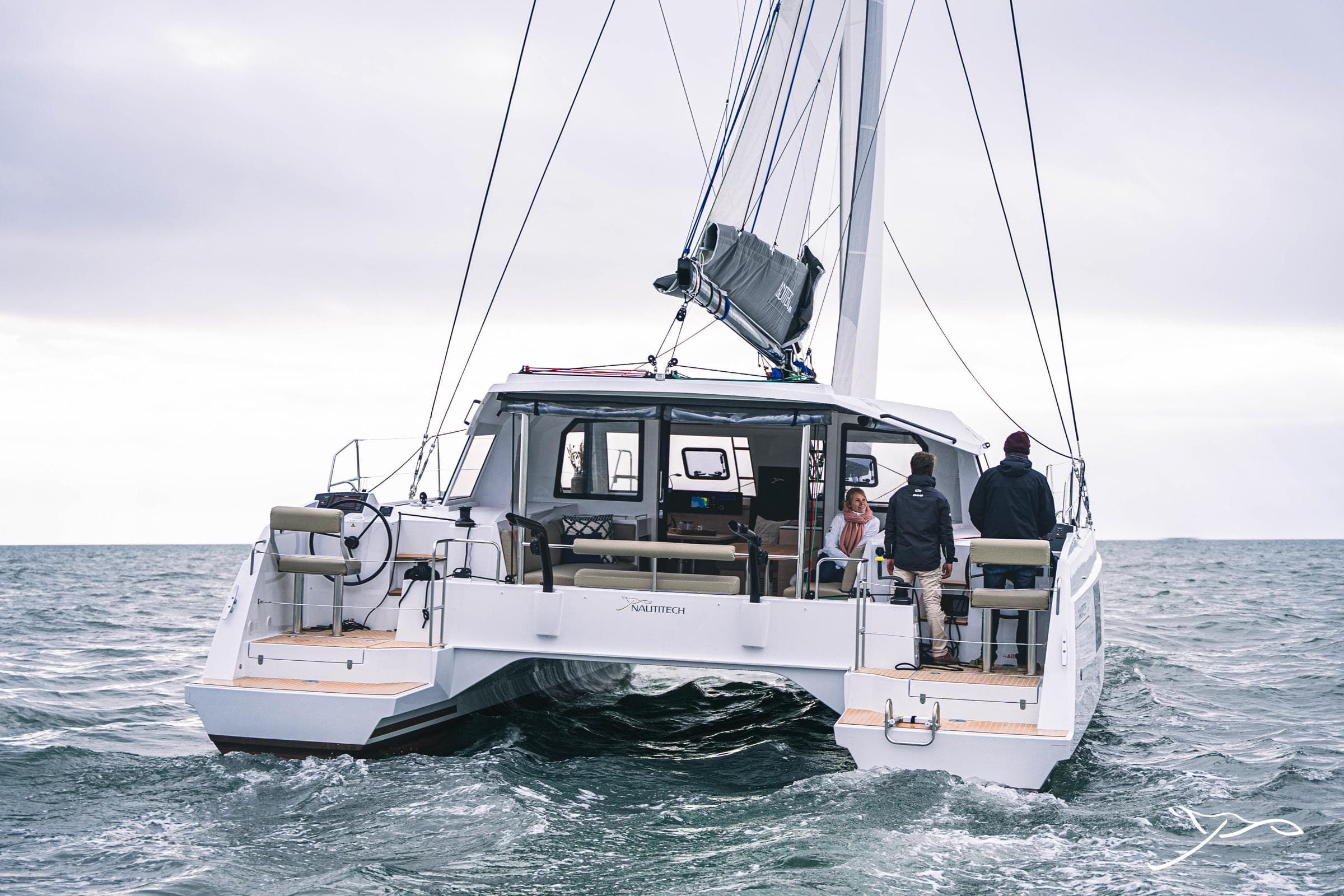 2025 Nautitech 40 Open catamaran sailing on open sea, rear view.