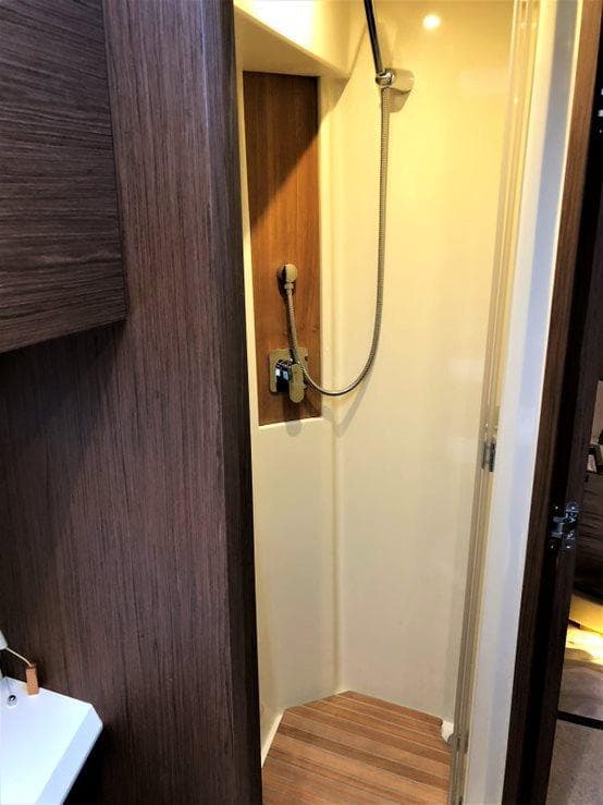 Shower area in 2017 Monte Carlo Yachts MCY 4, featuring wood accents and modern fixtures.