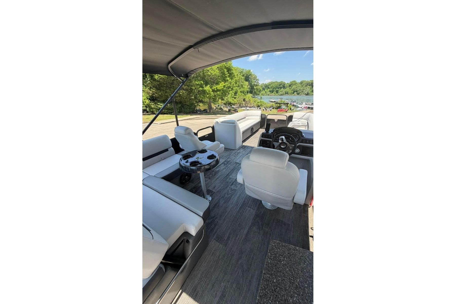 2023 Godfrey Sweetwater 2486 SFL pontoon boat interior with seating and steering console.