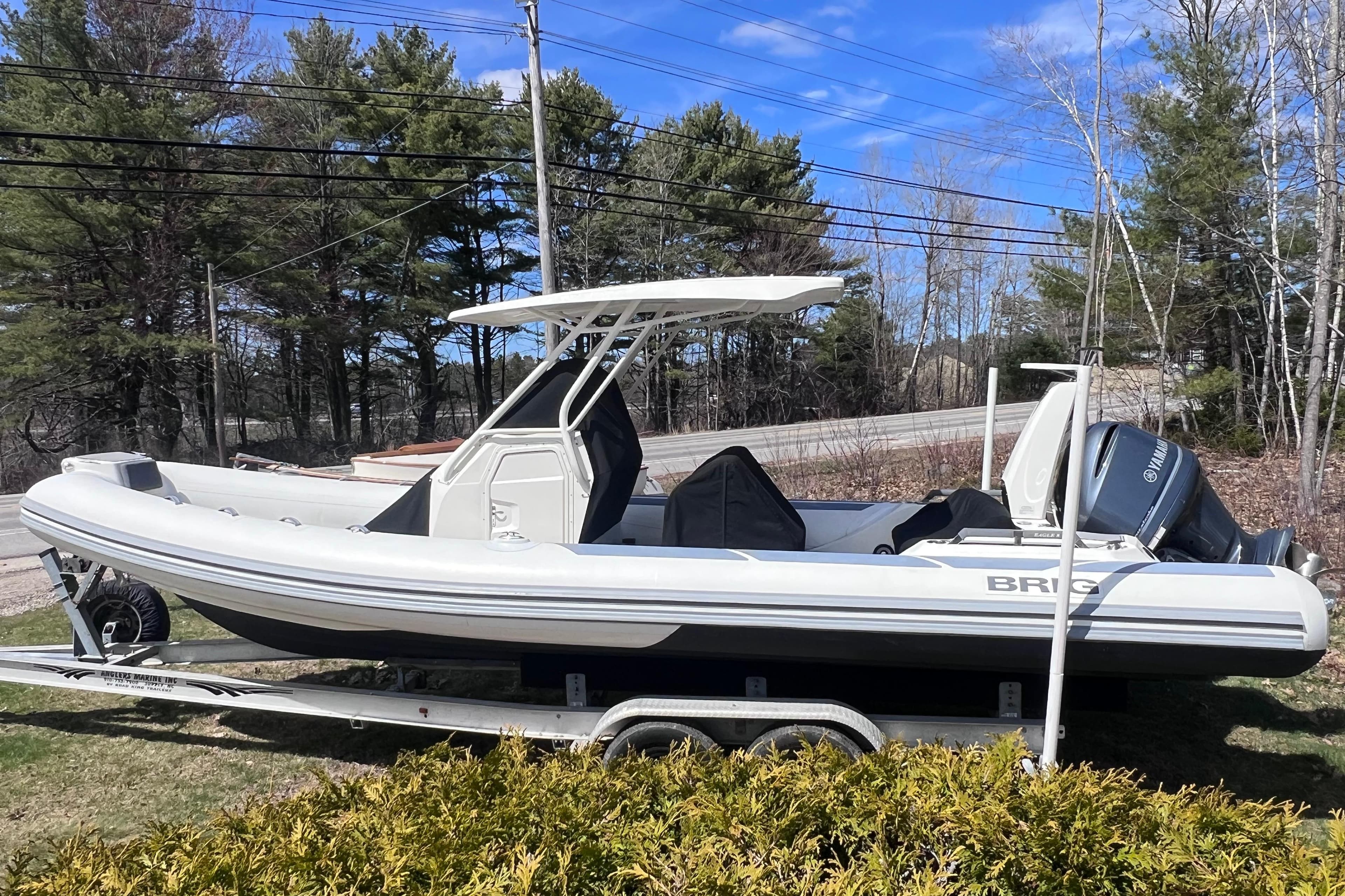 2022 Brig Eagle 8 boat on trailer, parked outdoors with trees in background.