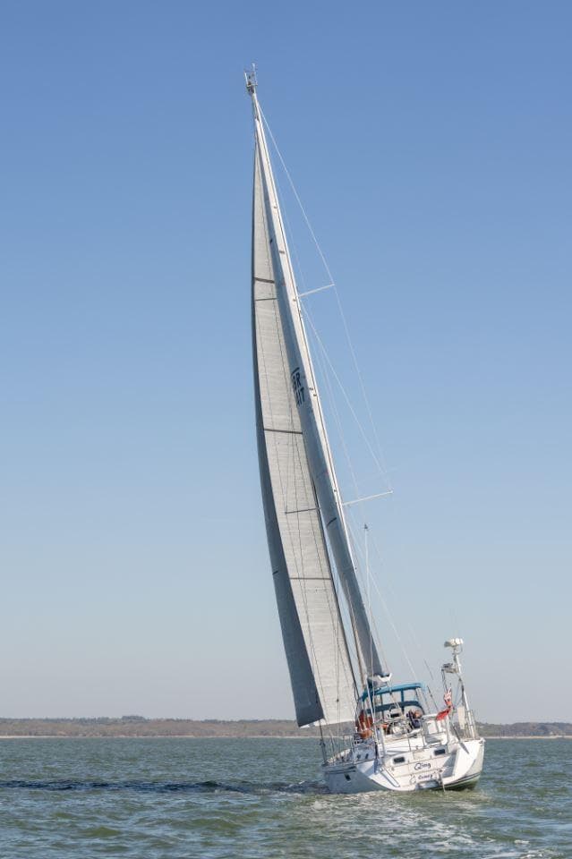 Sailing yacht Hylas 54 Raised Saloon, 2001 model, gliding on open water under clear skies.