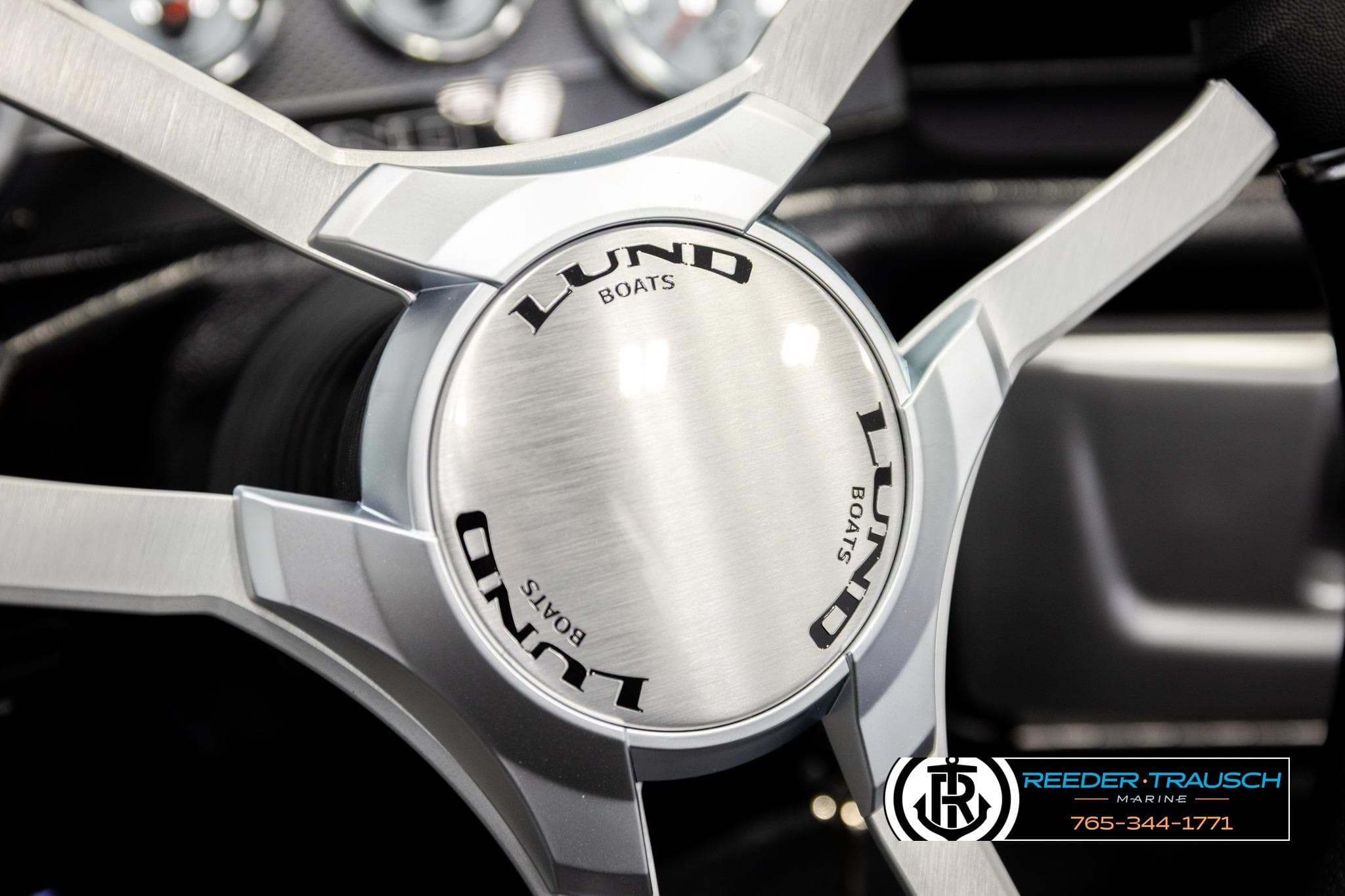 Steering wheel of 2026 Lund 1975 Pro-V Sport boat, featuring sleek metallic design.