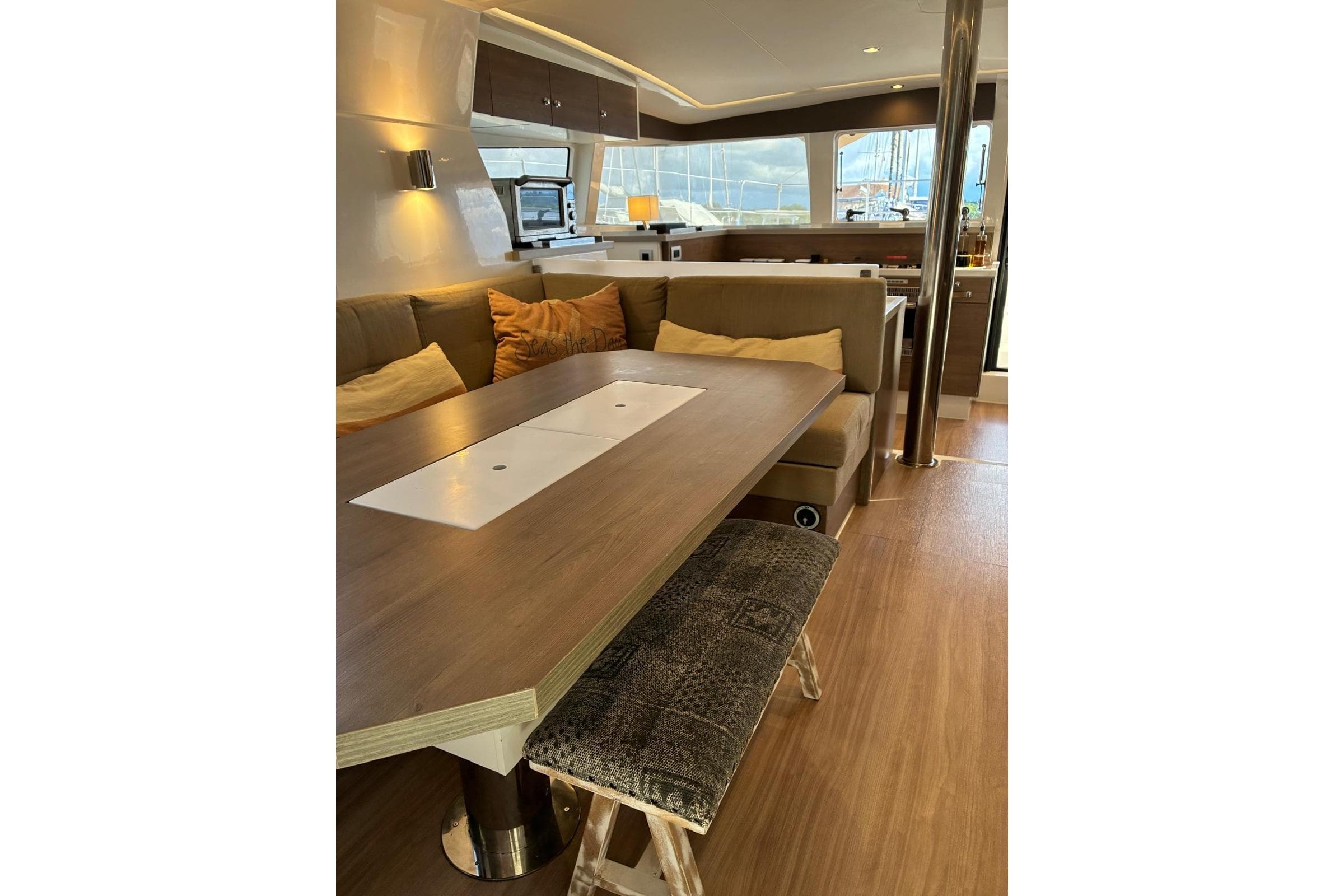 Luxurious interior of 2023 Bali 4.2 yacht with modern dining area and cozy seating.