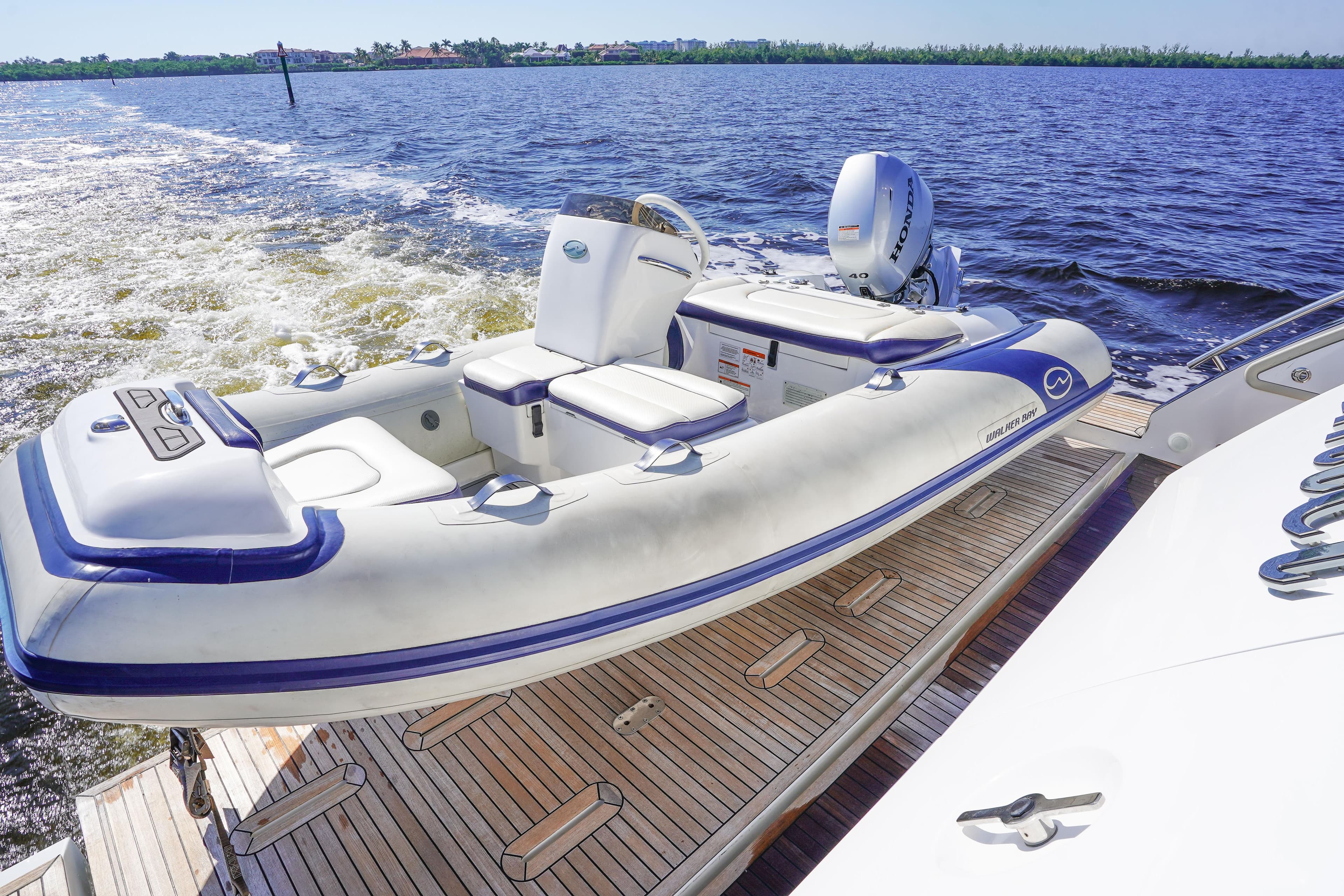 Azimut 66 Flybridge 2017 yacht with inflatable boat on deck, cruising on open water.