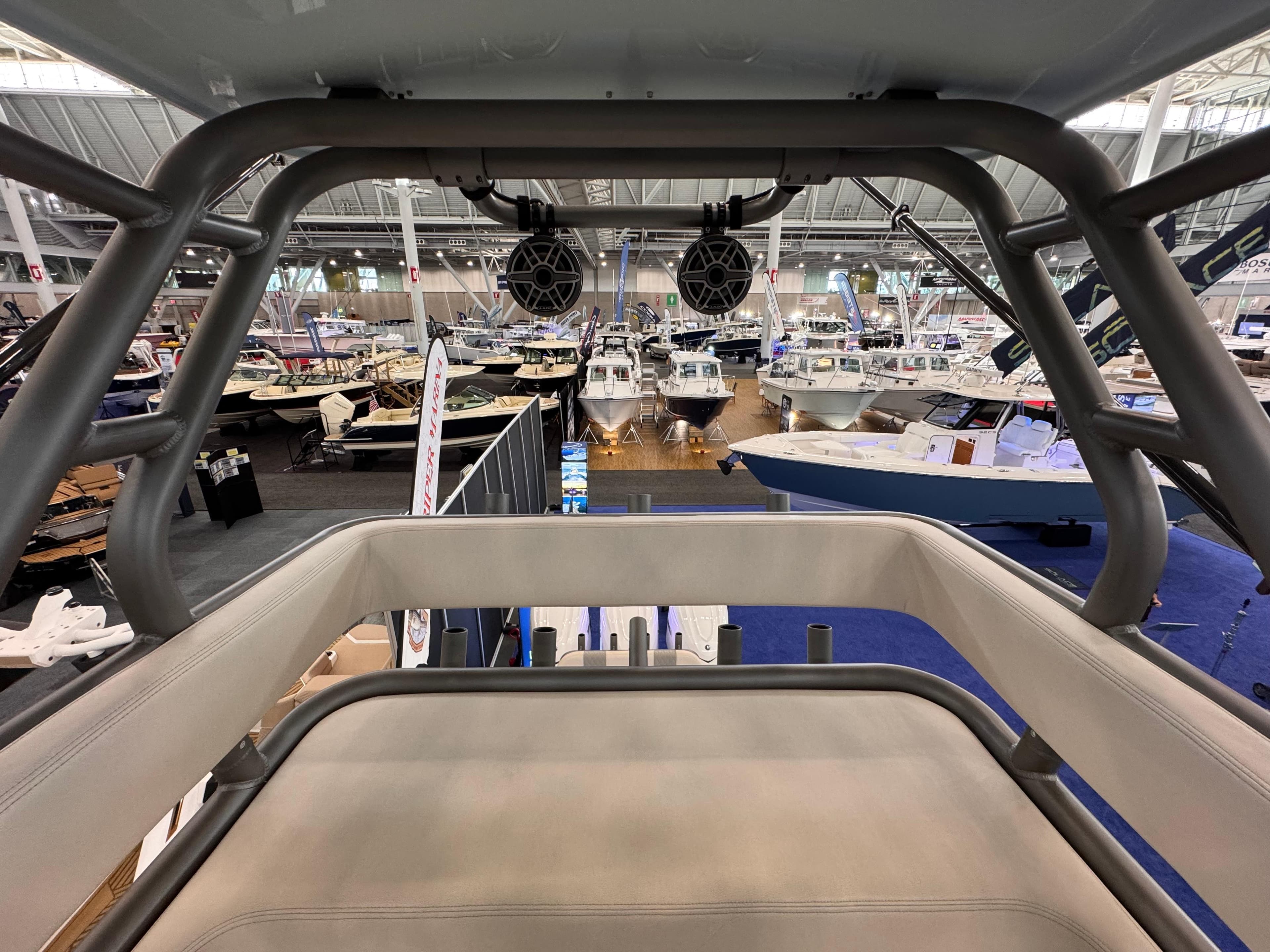 2025 Solace 37 CS boat interior at a boat show, showcasing seating and speakers.
