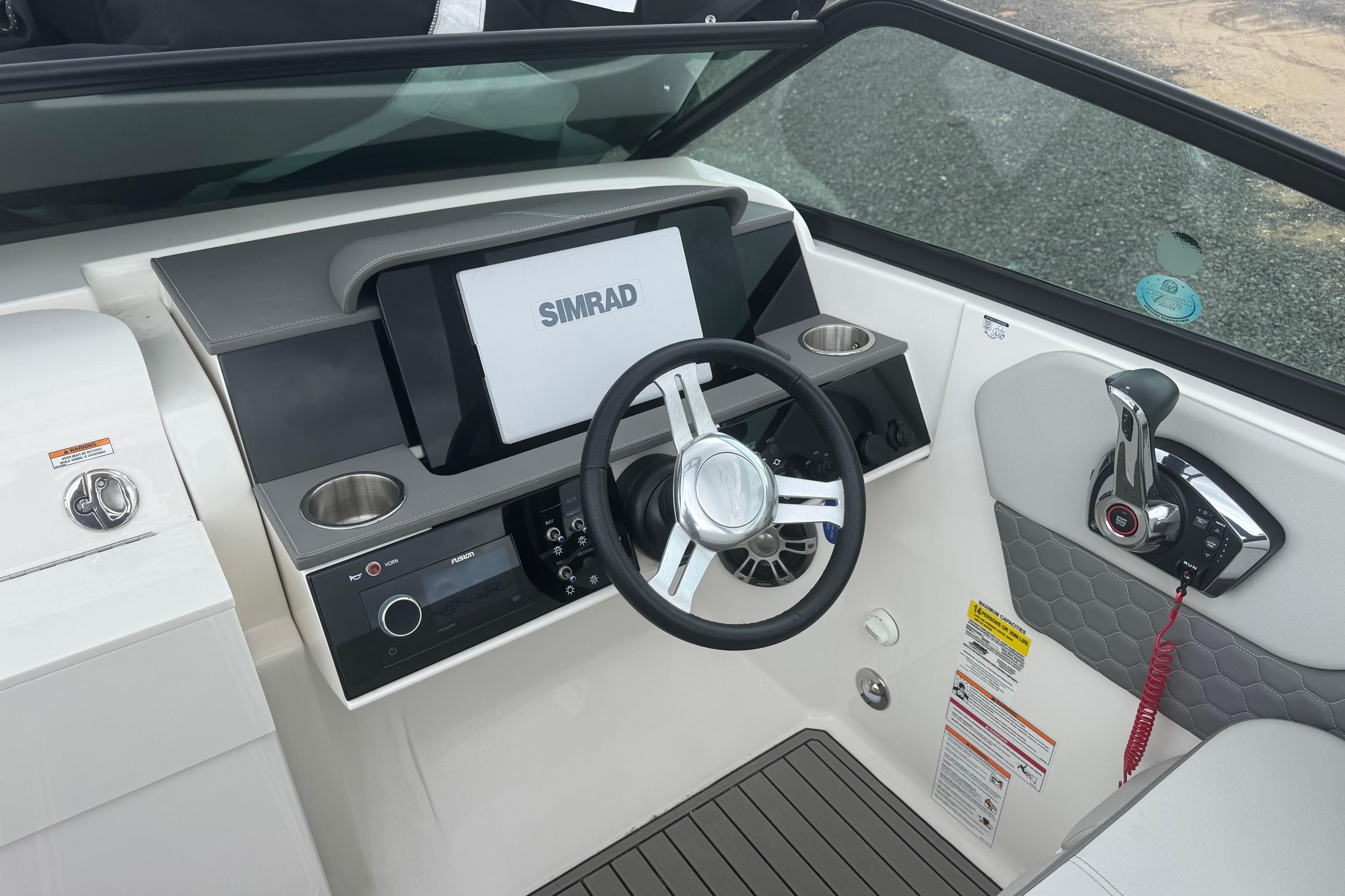 2024 Sea Ray SDX 250 Outboard helm with Simrad display and modern controls.