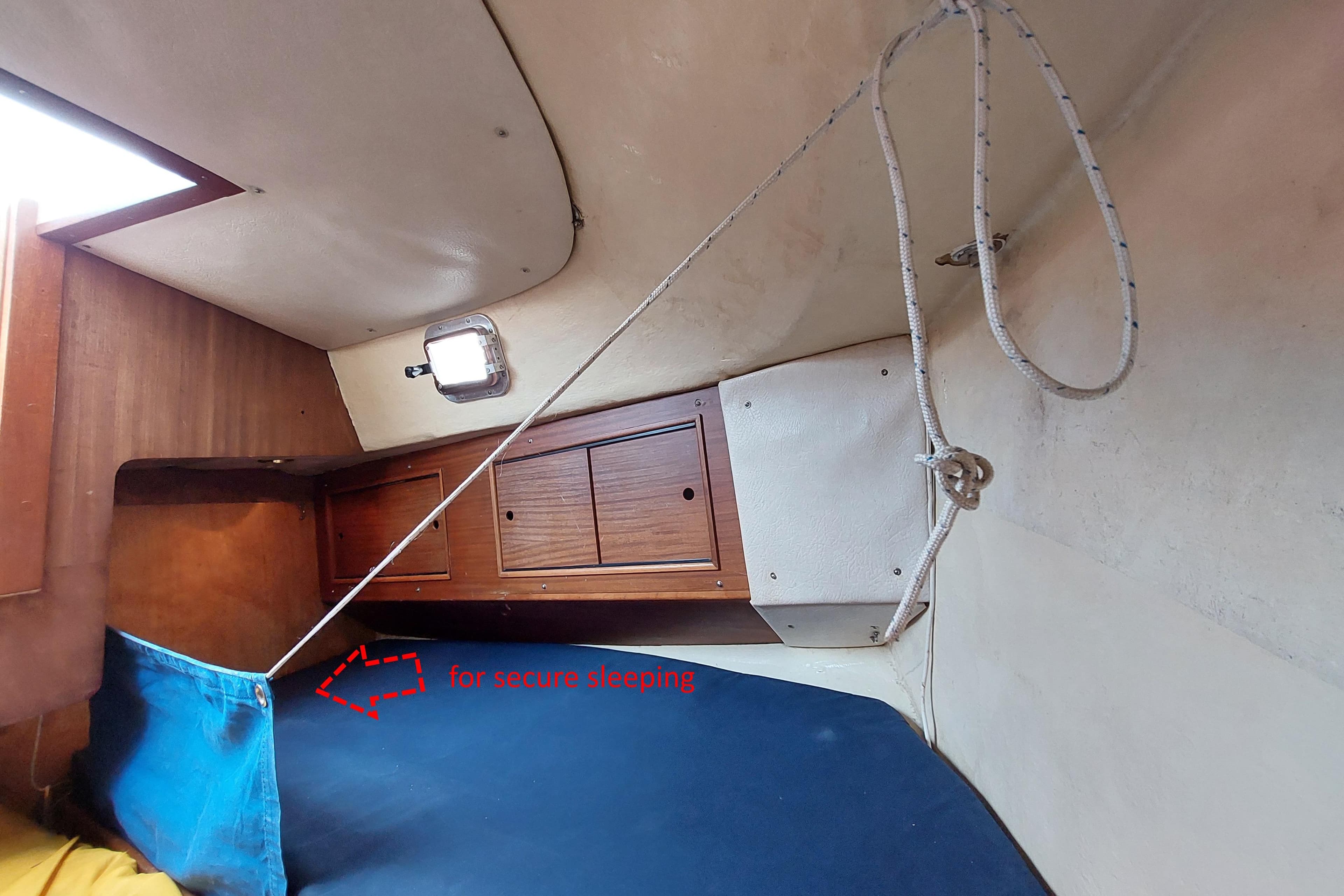 Interior of 1978 Westerly 33 sailboat cabin with secure sleeping setup.