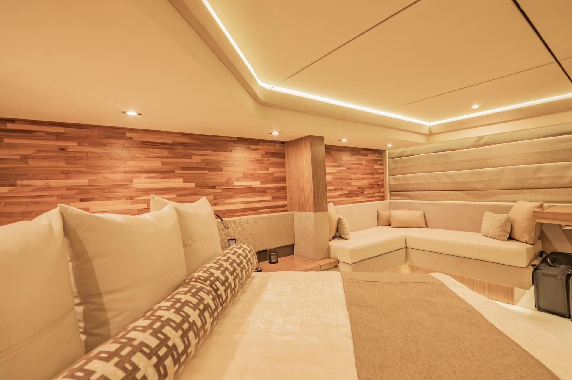 Luxurious interior of 2018 Sea Ray L590 yacht with modern wood paneling and plush seating.