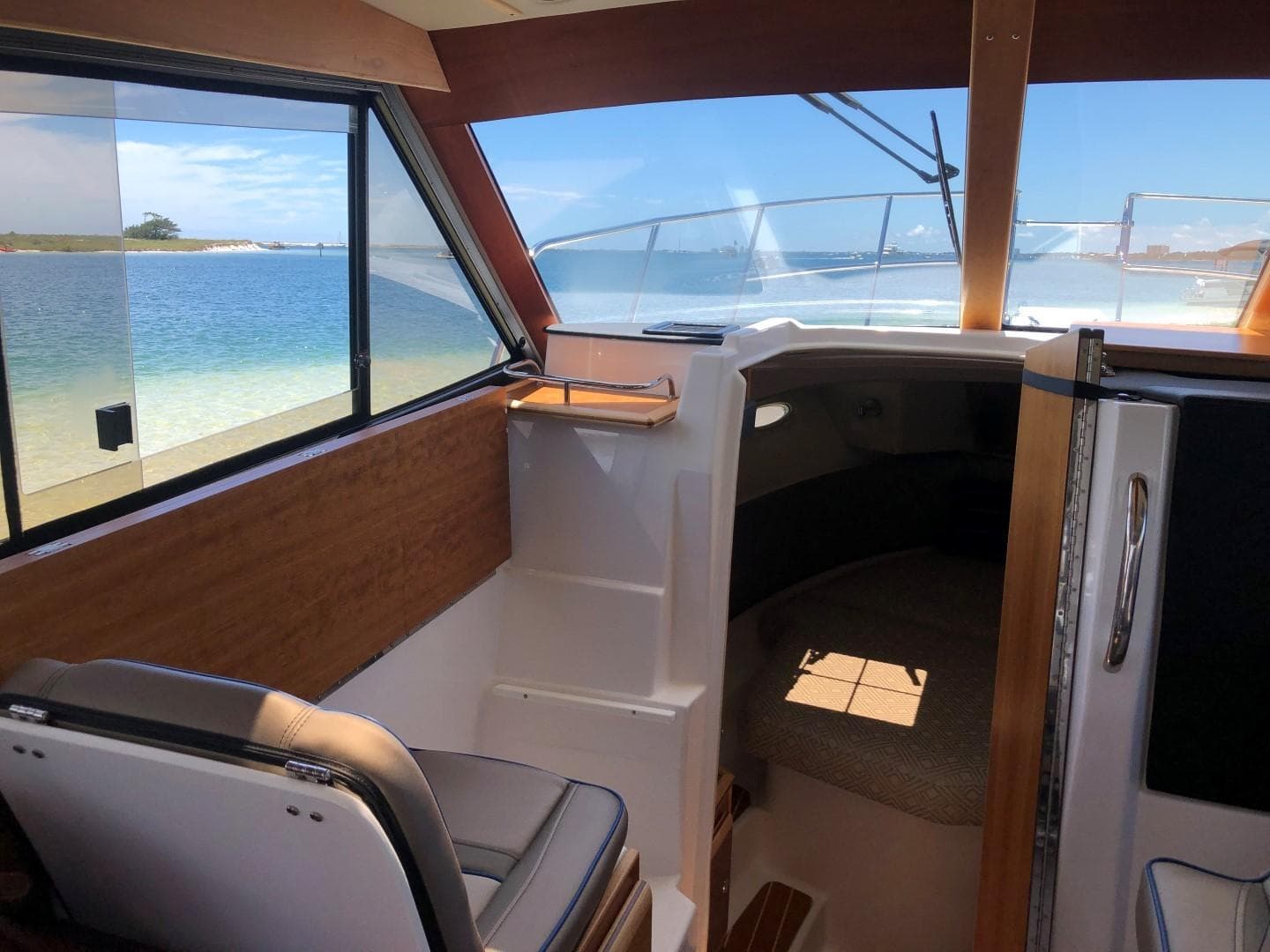 Interior view of 2025 Cutwater C-32 Sedan boat with ocean backdrop.