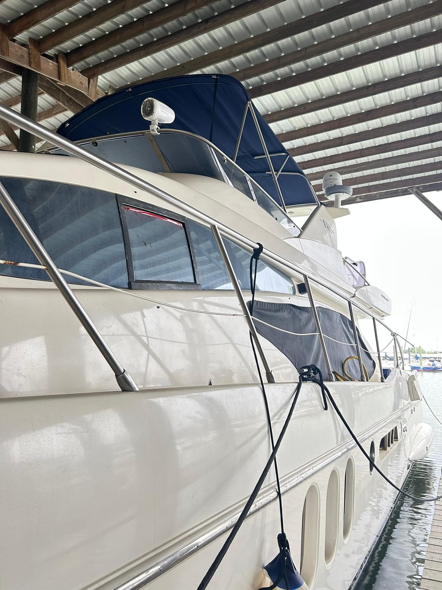 2006 Azimut 62 yacht docked under a covered marina.
