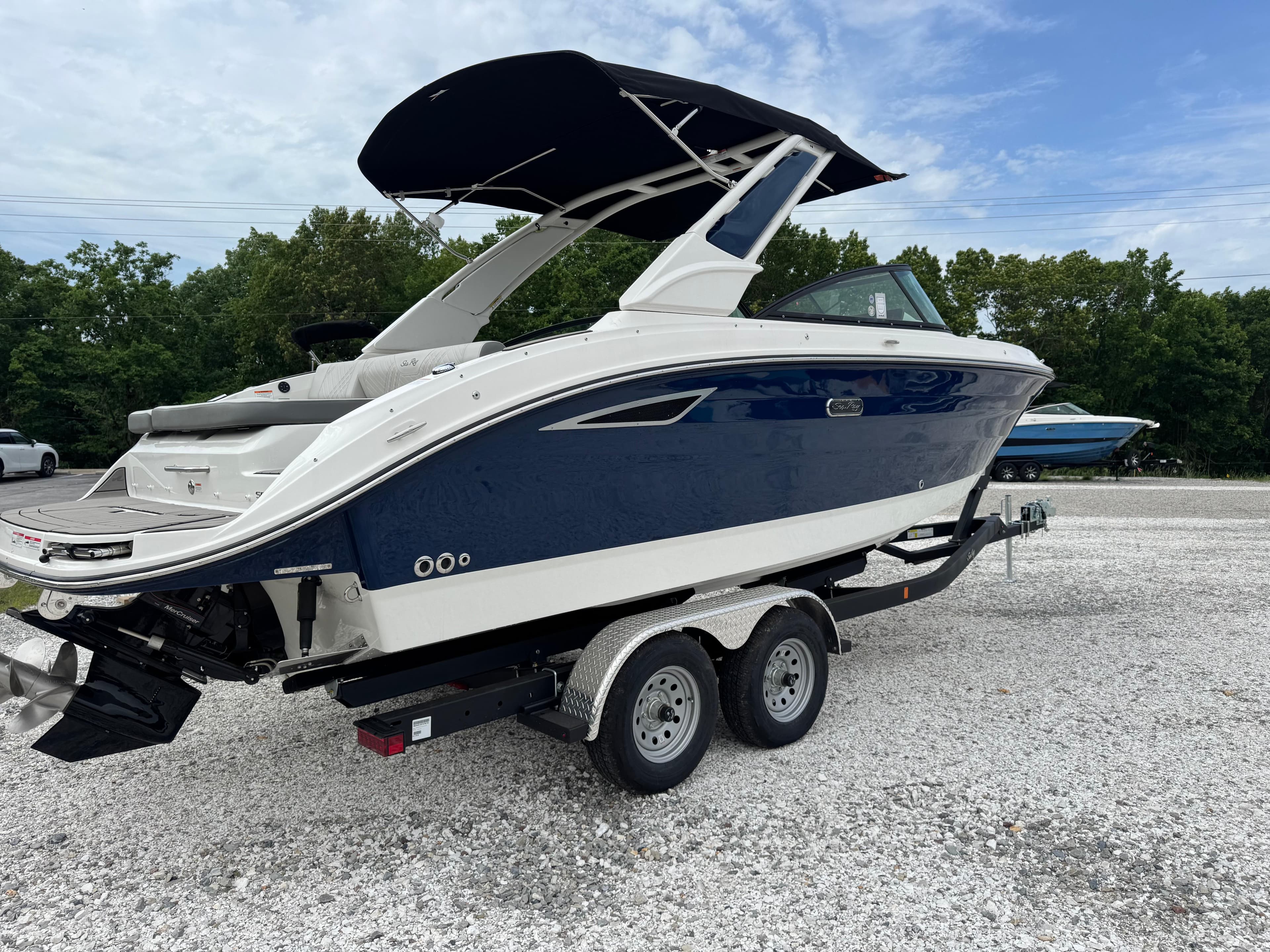 2025 Sea Ray SDX 250 boat on trailer, featuring sleek design and blue hull.
