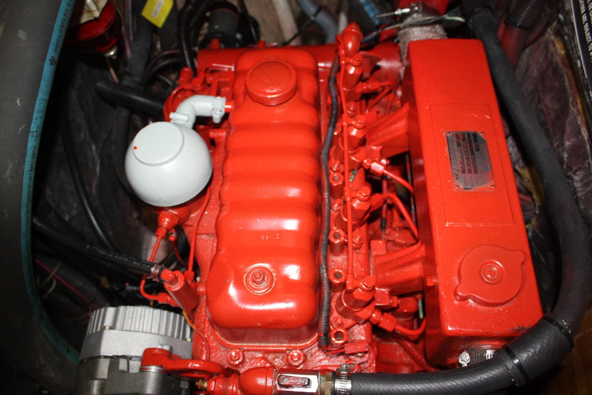 Red engine of a 1981 Bristol 40, showcasing detailed mechanical components.