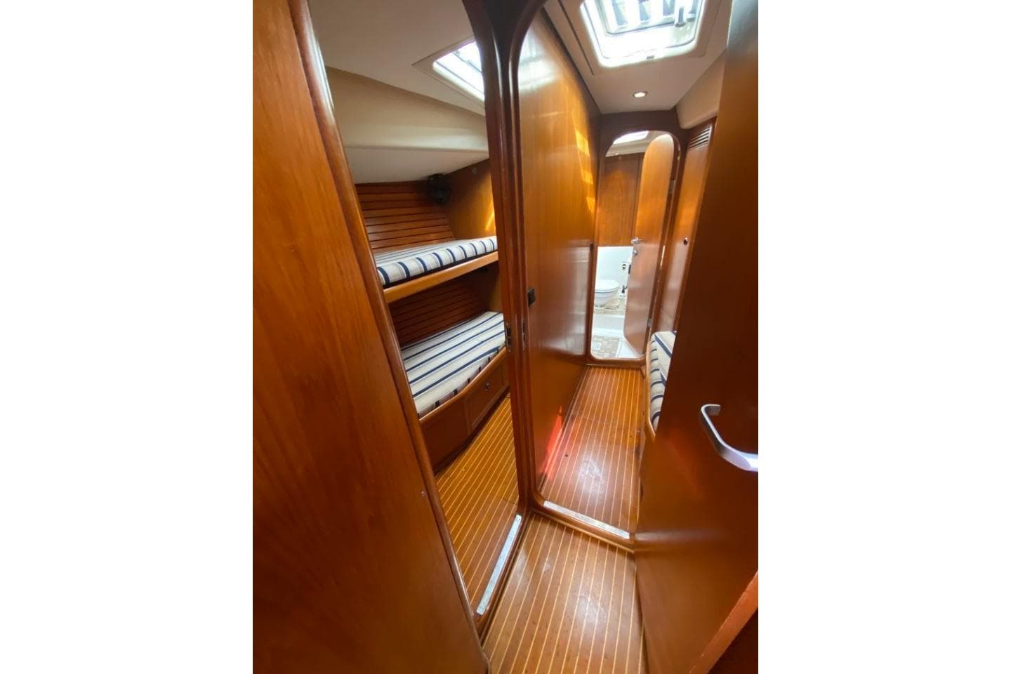 Interior of 1996 Nautor Swan 48 yacht with wooden finish and bunk beds.