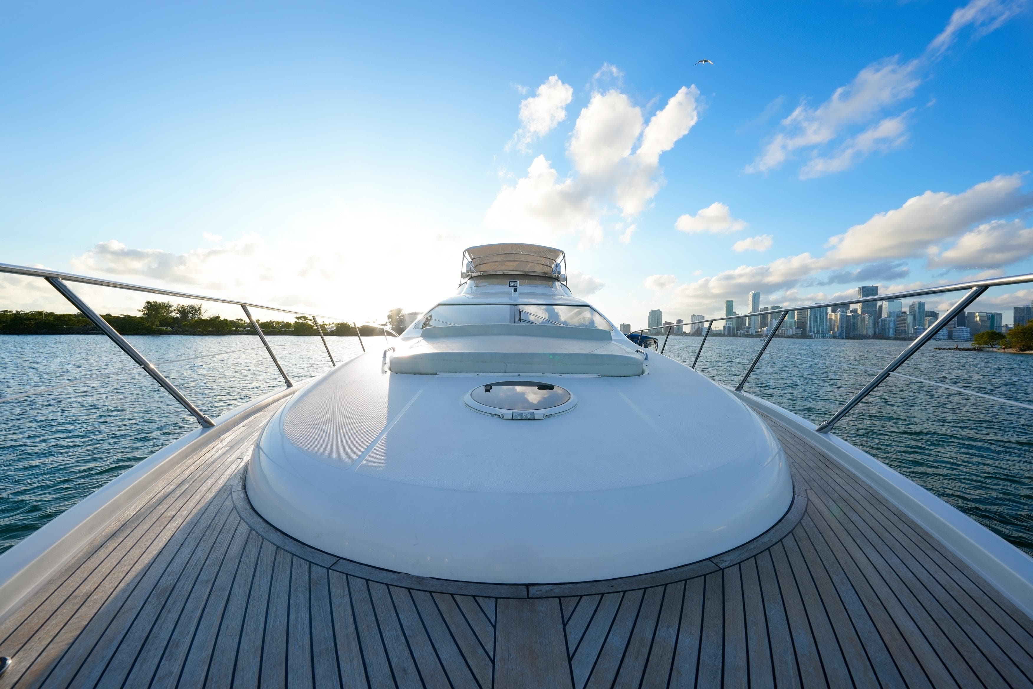 2007 Azimut 68E yacht deck with city skyline and ocean view.