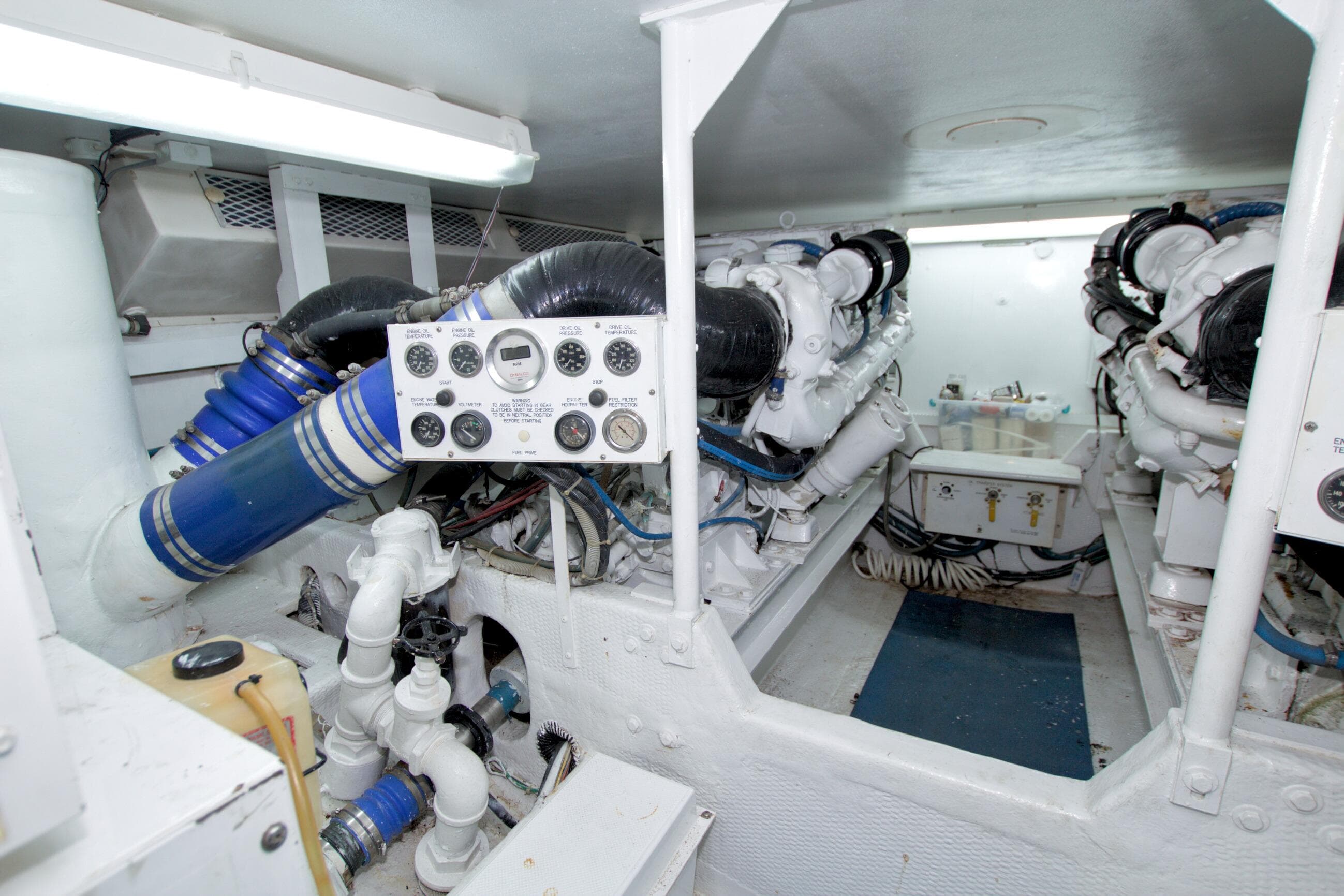 Engine room of a 1990 Viking 53 Convertible yacht, featuring complex machinery and control panels.