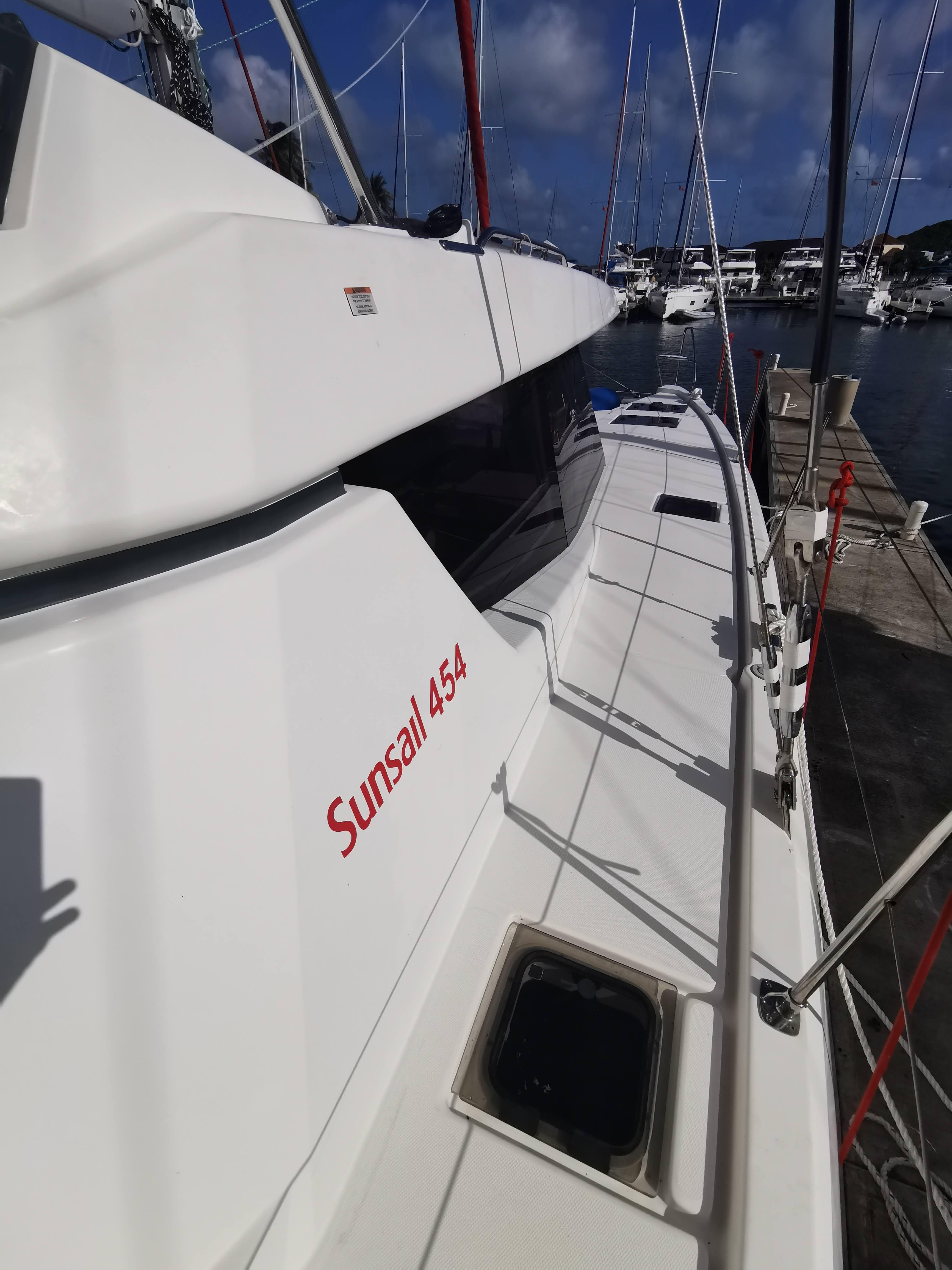 Sailing yacht Leopard 45, 2022 model, docked at marina under clear blue sky.
