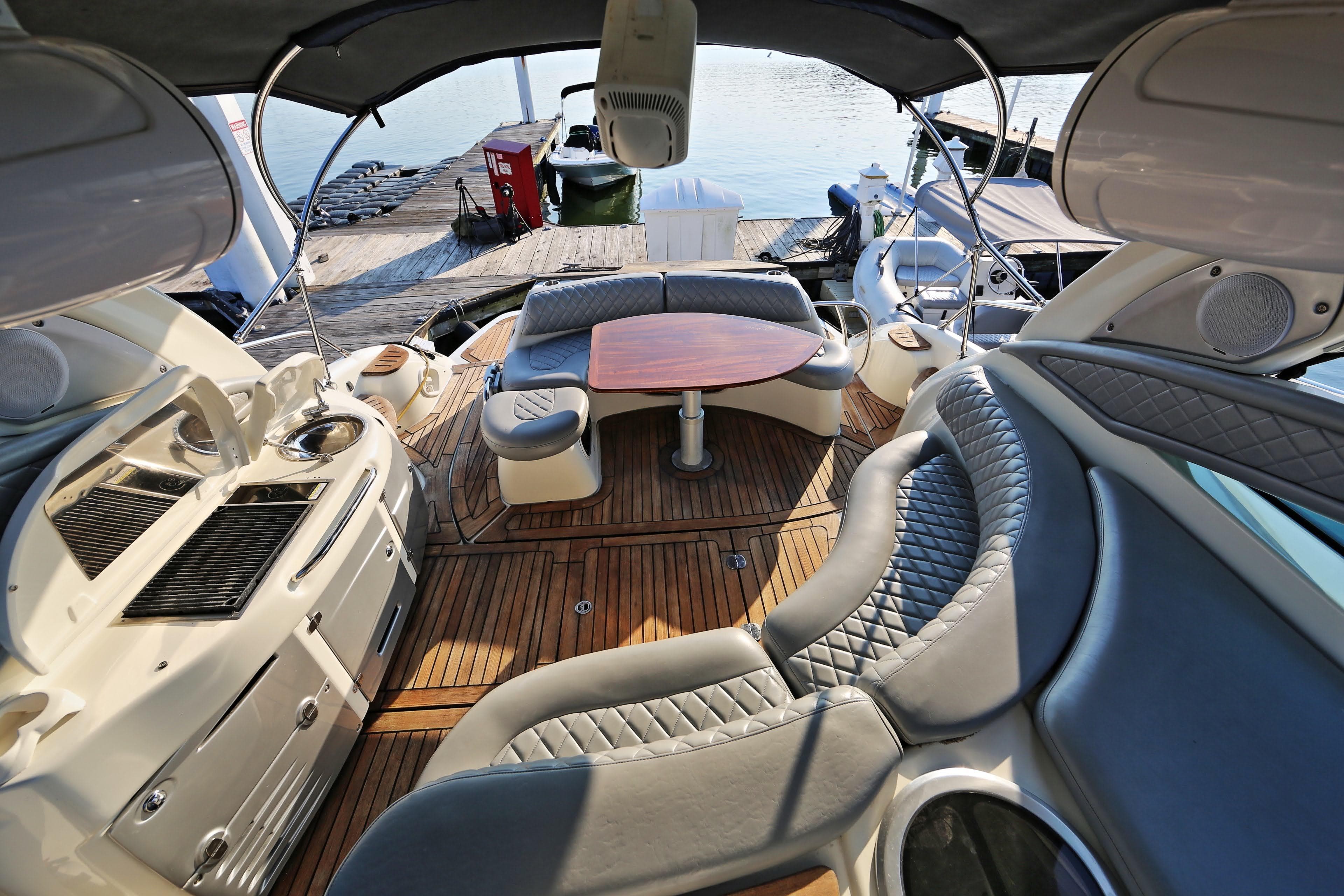 Luxurious 2008 Cranchi Mediterranee 43 yacht interior with elegant seating and wooden deck.
