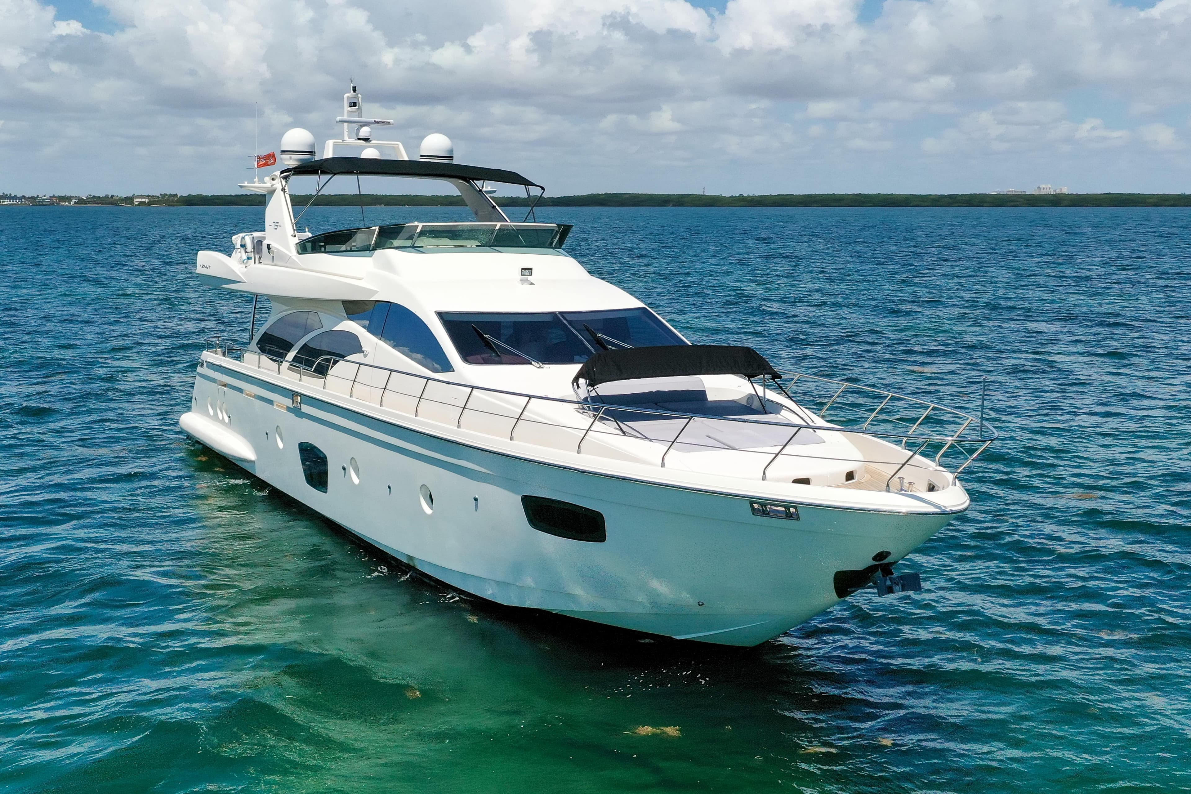 Luxury 2009 Azimut 75 yacht cruising on clear blue waters.