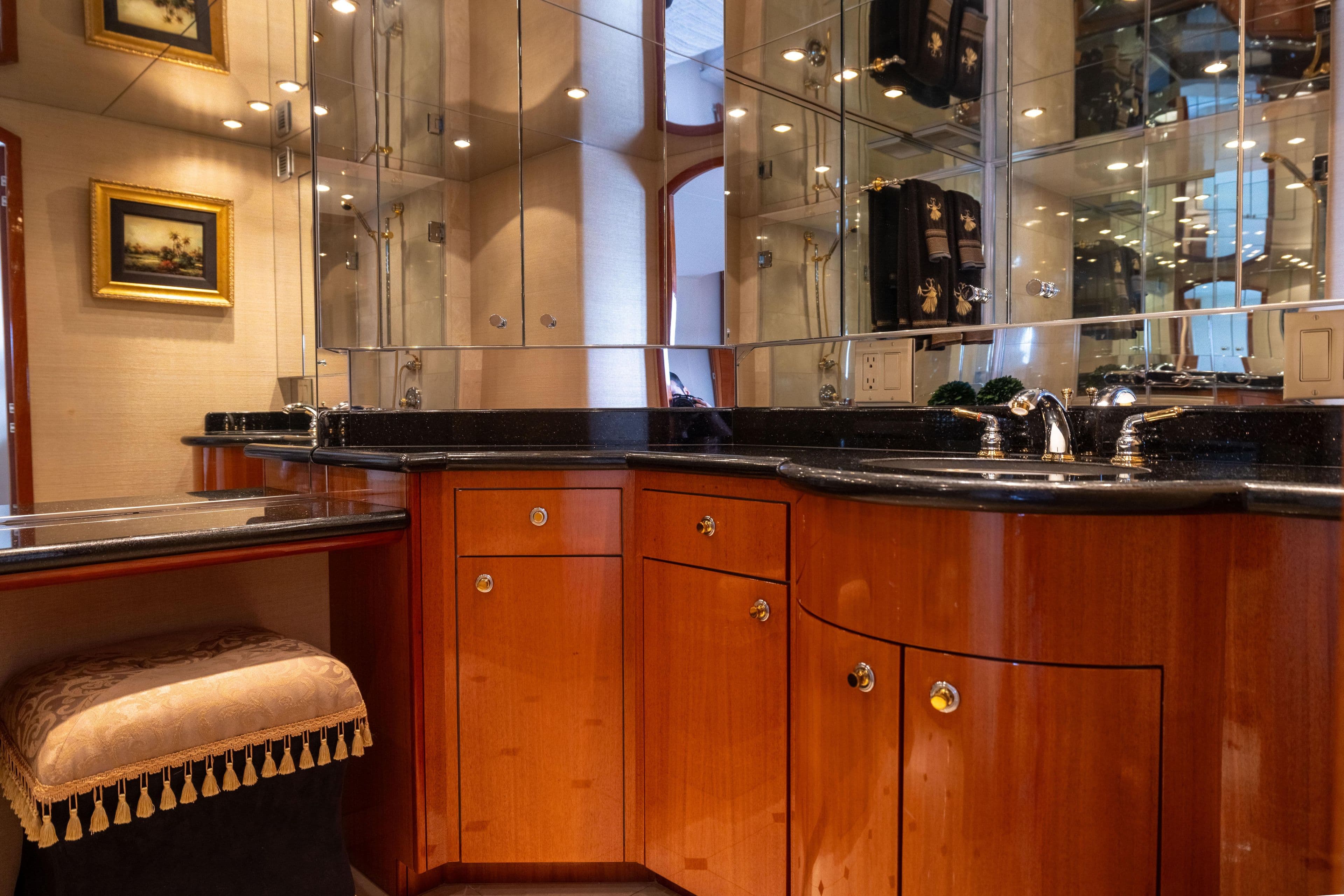 Luxurious bathroom interior of 2005 Hatteras 80 Motor Yacht with elegant wood cabinetry.