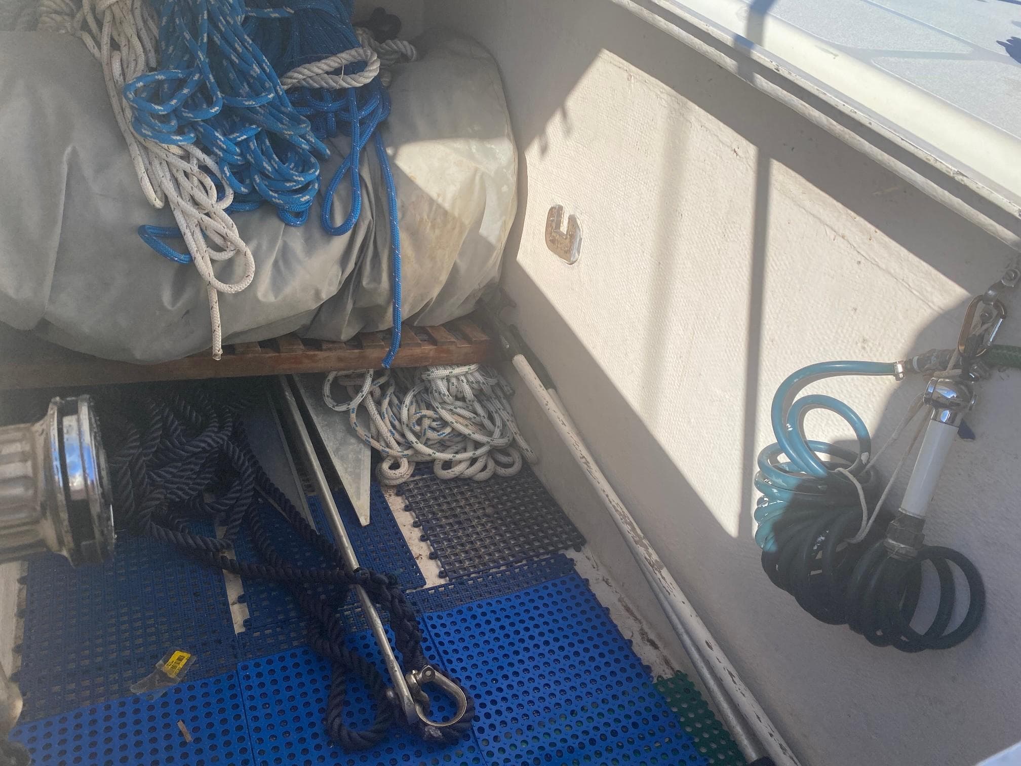 Storage area on a 1995 Voyage Mayotte 47 sailboat with ropes and equipment.