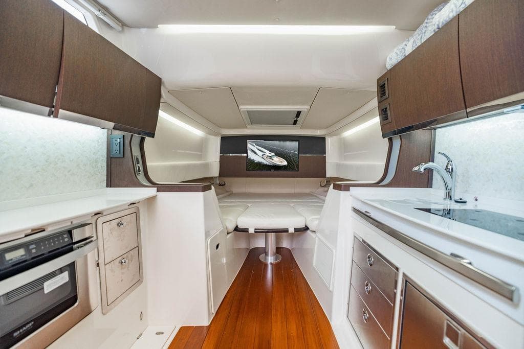 Luxurious interior of 2022 Grady-White Canyon 456 boat with modern kitchen and seating area.