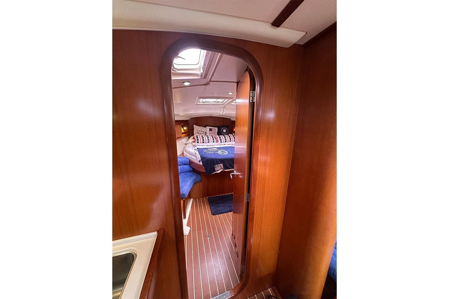Interior view of 2007 Dufour 455 GL yacht cabin with wooden finish.