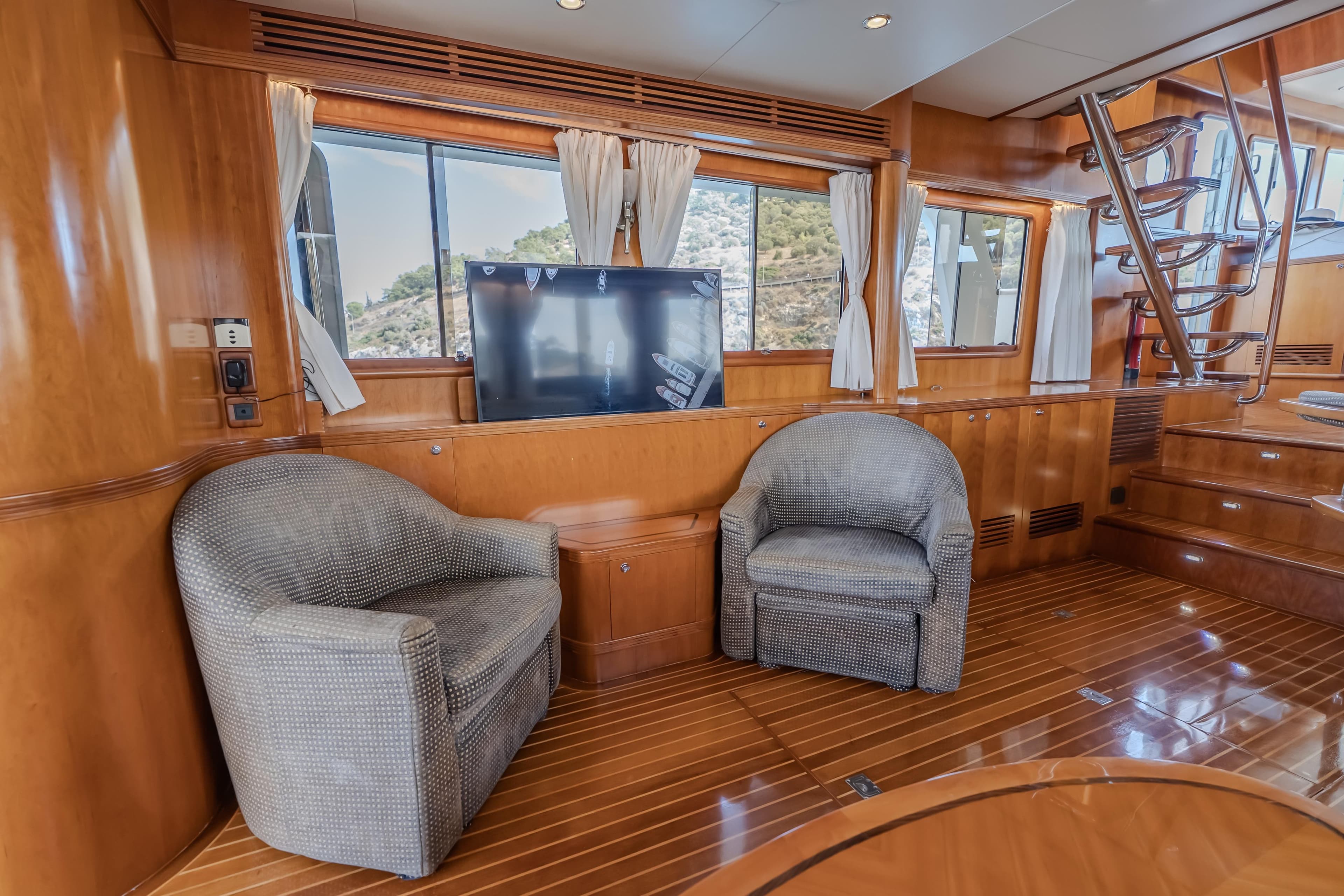 Luxurious 2004 Selene 62 yacht interior with plush seating and elegant wood finishes.