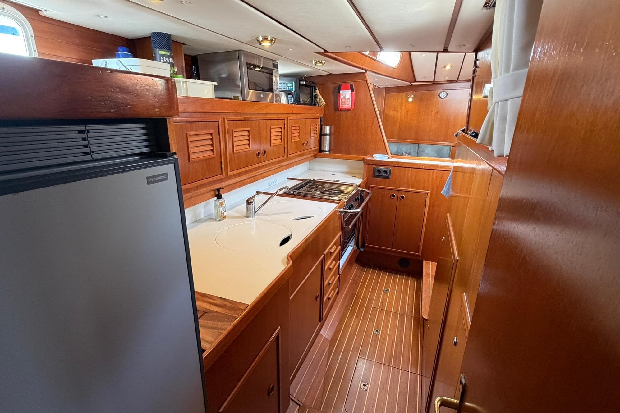 1997 Contest 46-48 yacht kitchen with wooden cabinetry and modern appliances.