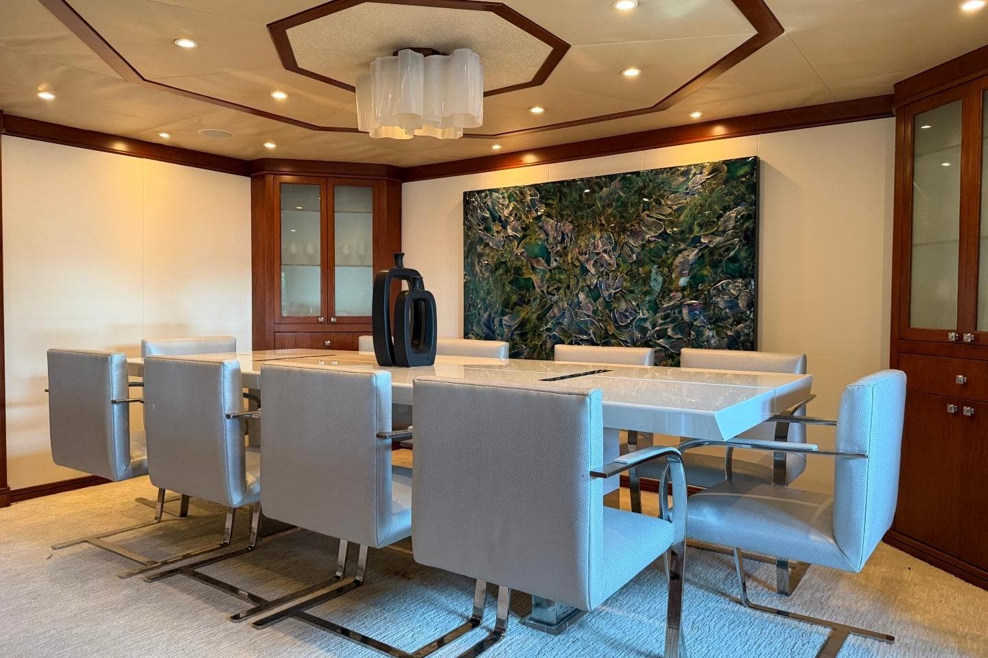 Luxurious dining area on 1990 Heesen 144 yacht with modern decor and elegant furnishings.