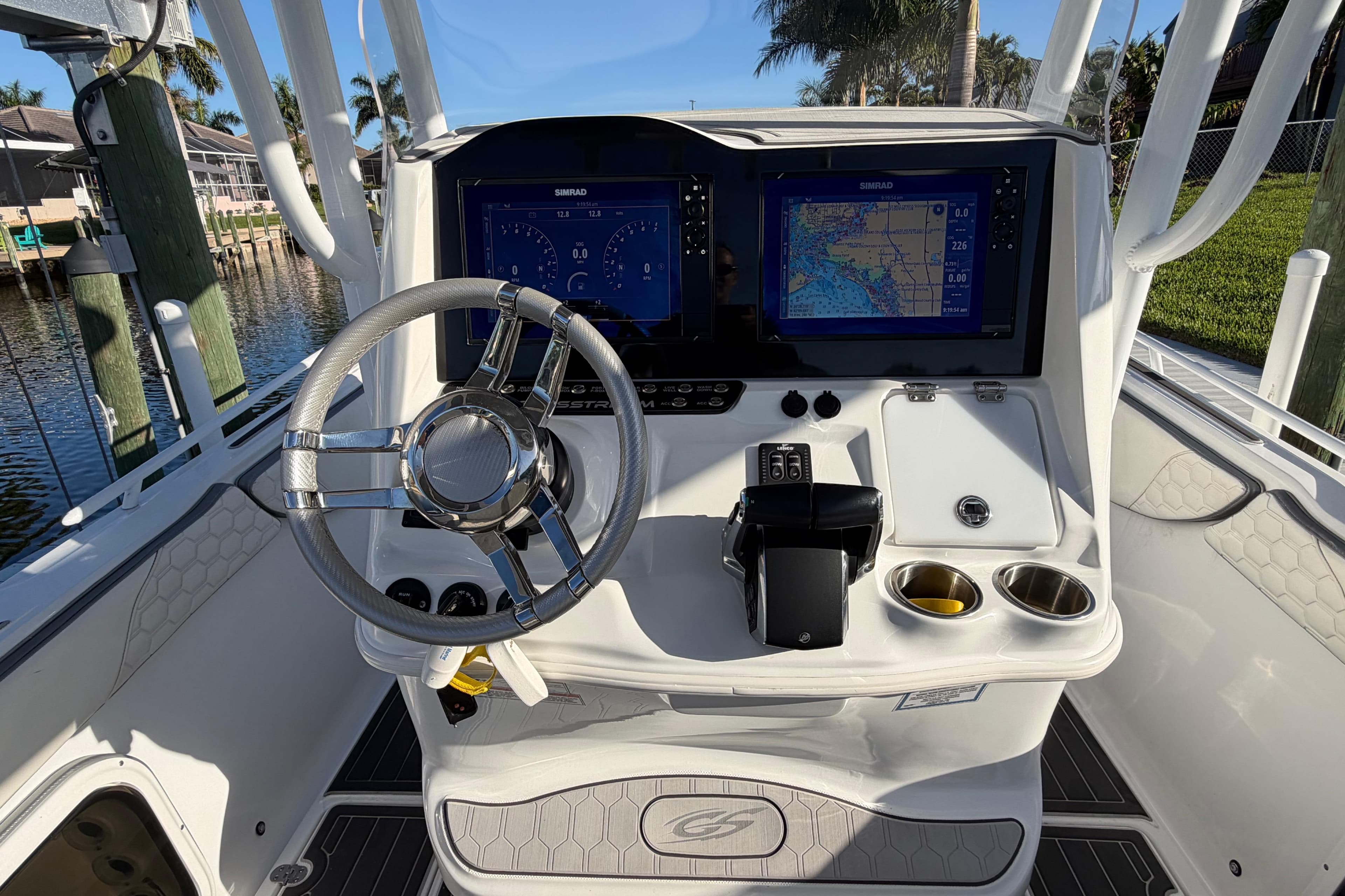 2022 Glasstream 328 Pro-XS boat dashboard with dual Simrad displays and steering wheel.