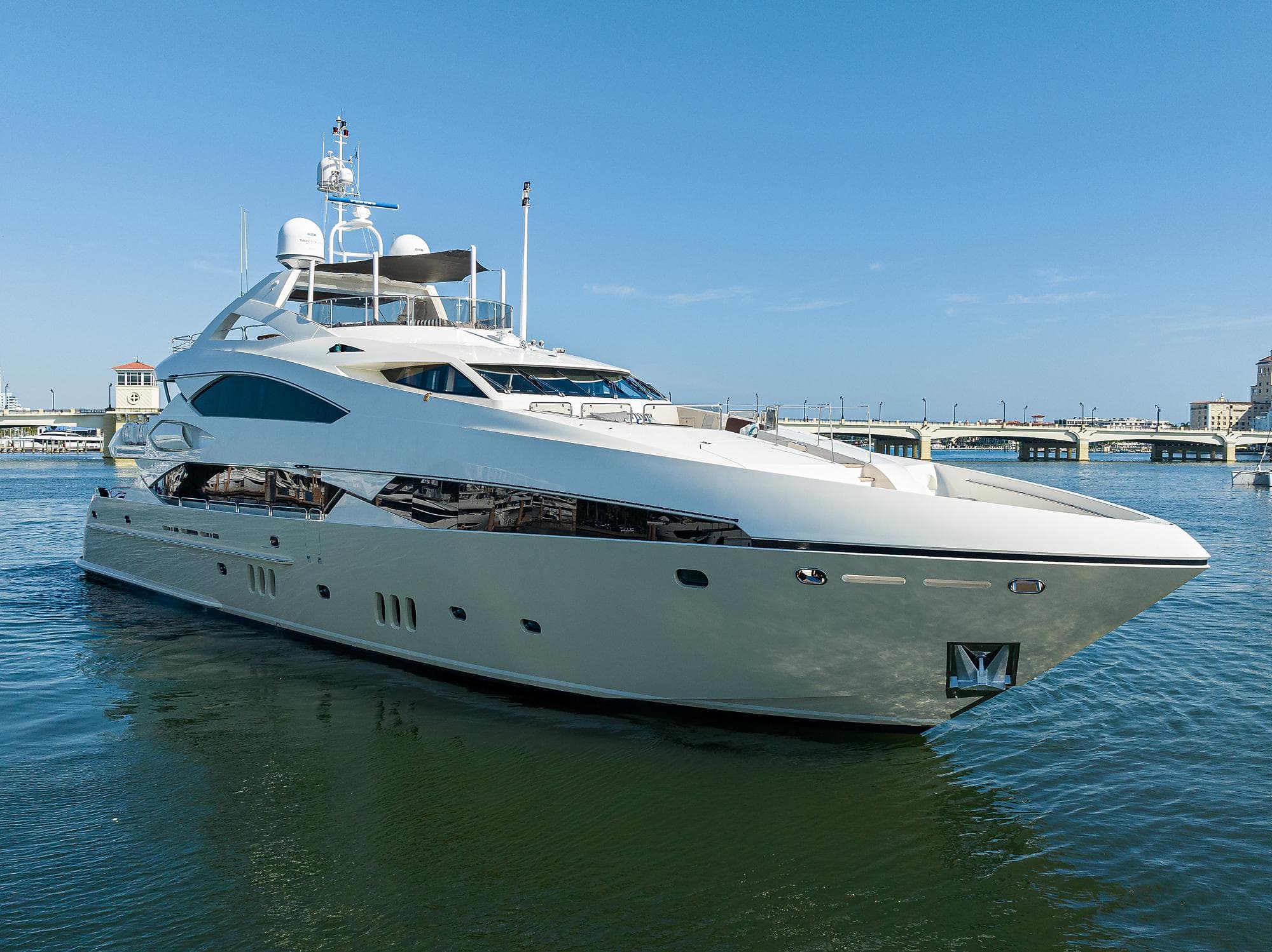 2009 Sunseeker Trideck yacht on calm water with clear blue sky.