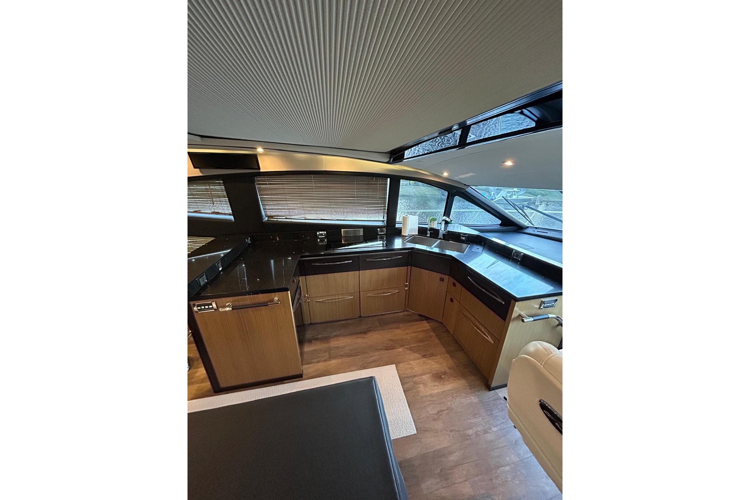 Luxurious interior of 2016 Sea Ray L650 yacht with modern kitchen design.