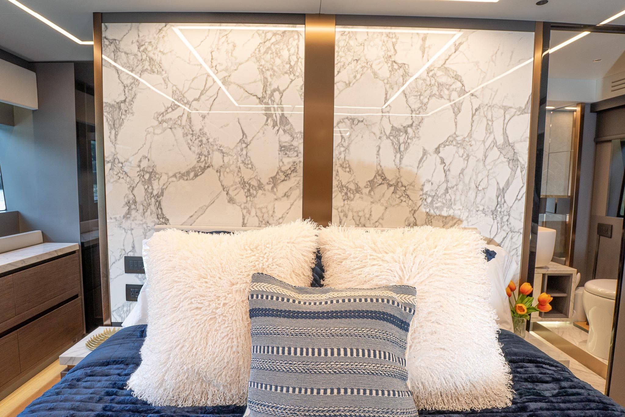 Luxurious 2024 Explorer EX62 interior with plush bedding and elegant marble accents.