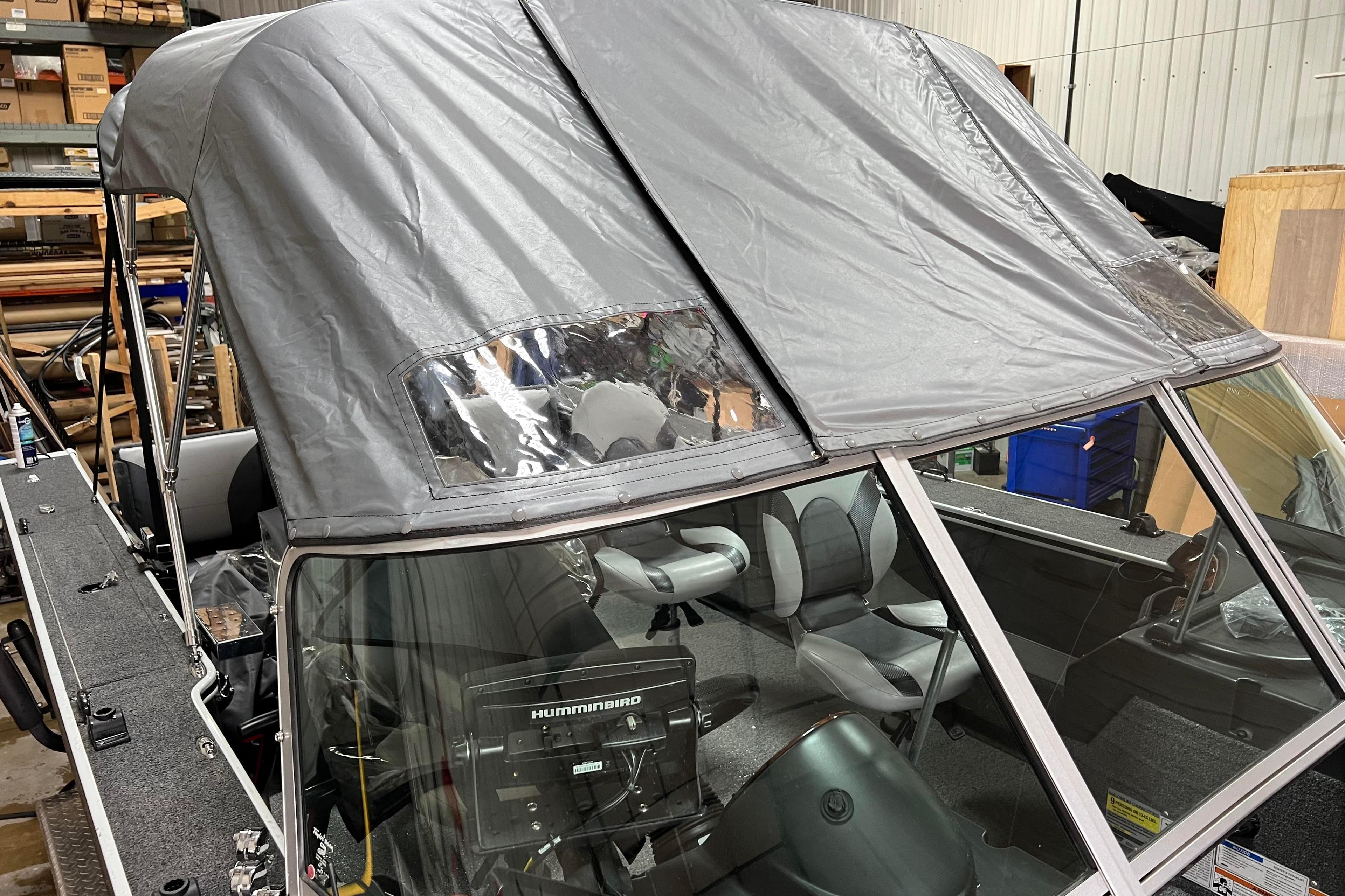 2015 Alumacraft Trophy 205 Sport boat with canopy in a storage facility.